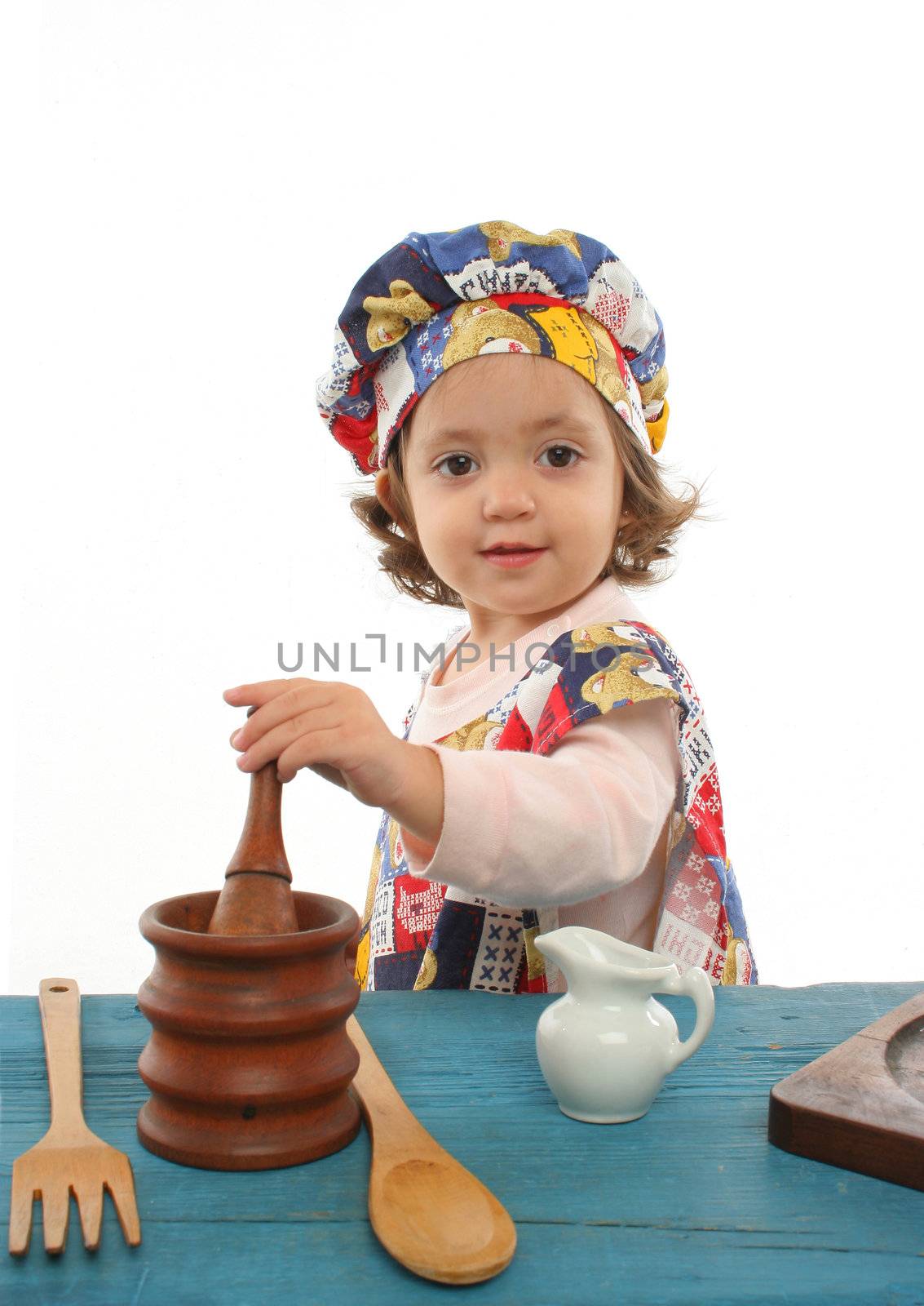Little girl cooking dressed at a cheff by Erdosain