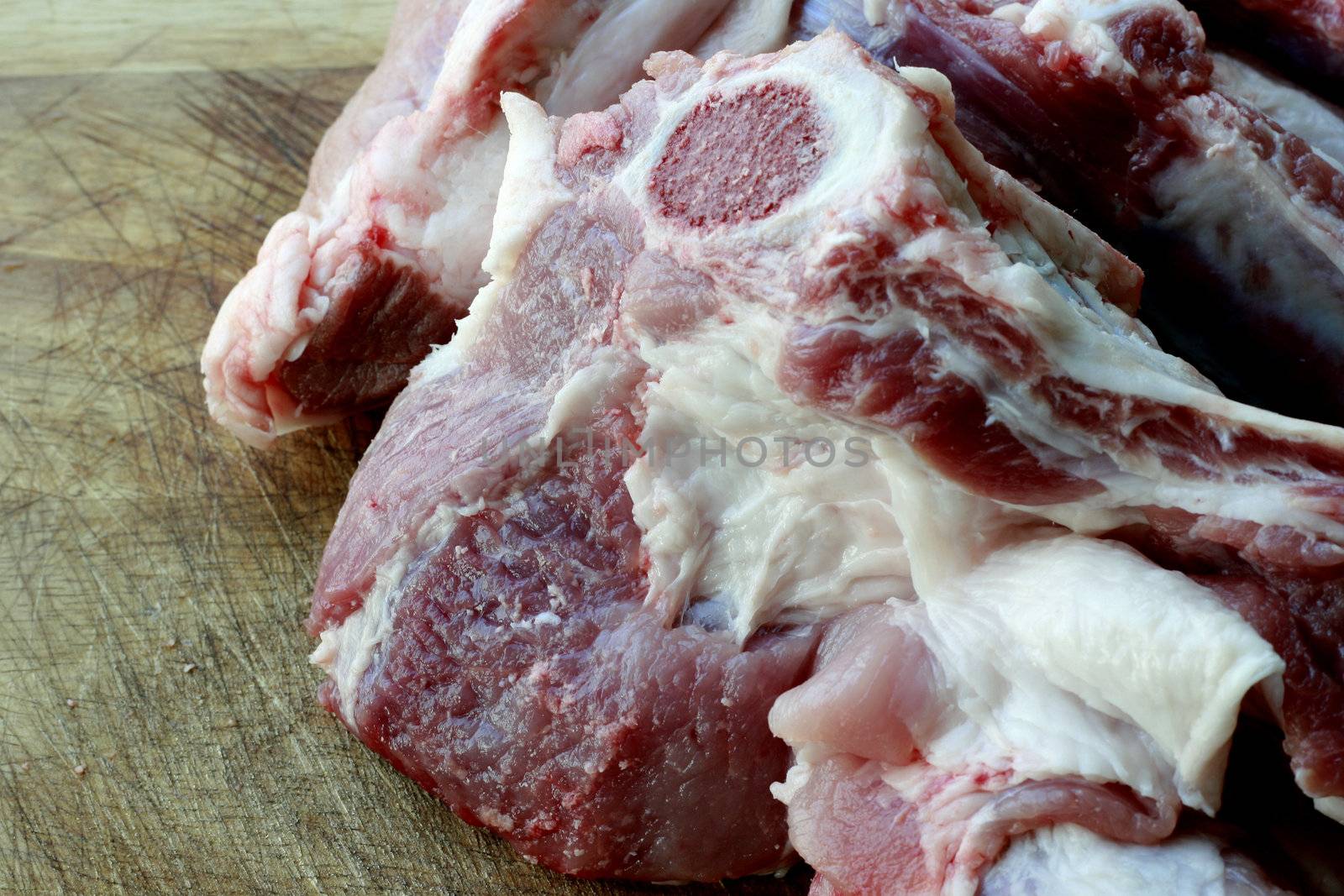 Slices of fresh raw meat  in a chopping board