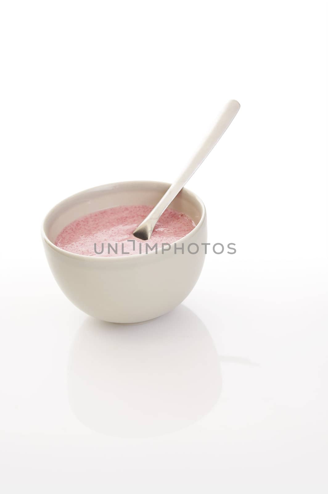 Pink fruit porridge over a white background