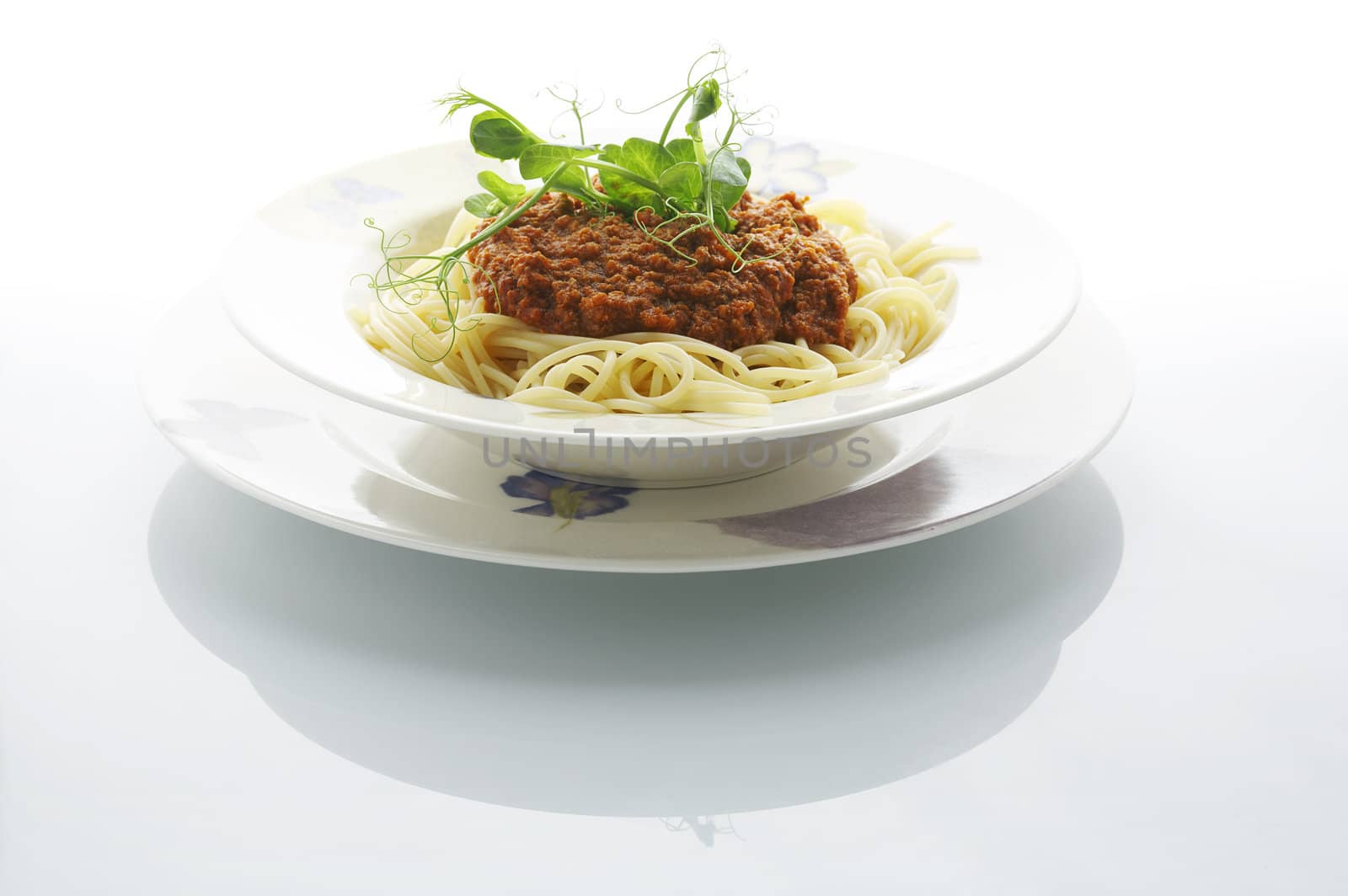 Spaghetti bolognese plate on shiny white table at the restaurant