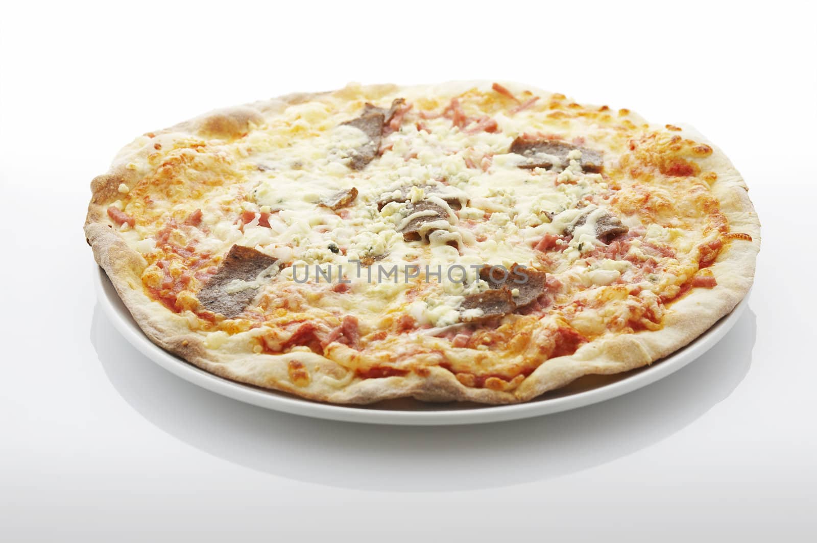 Pizza (filled with kebab, ham and blue cheese) on the plate over white background