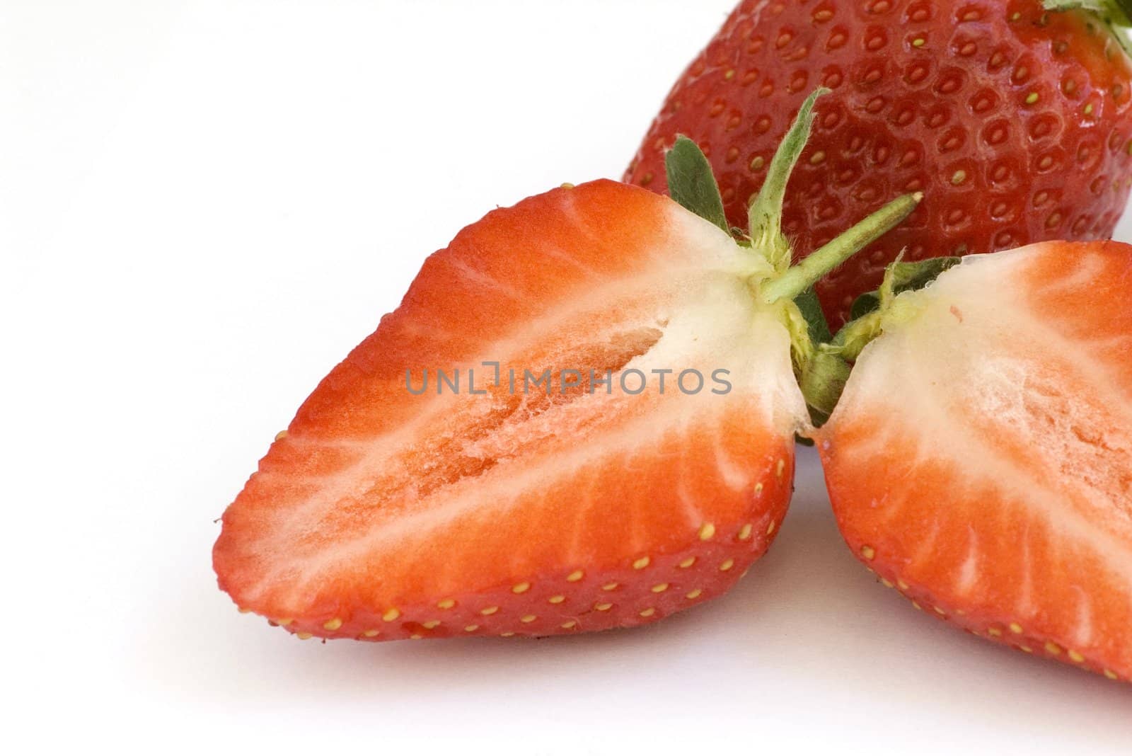 Healthy red strawberry fruit sliced and isolated on white background