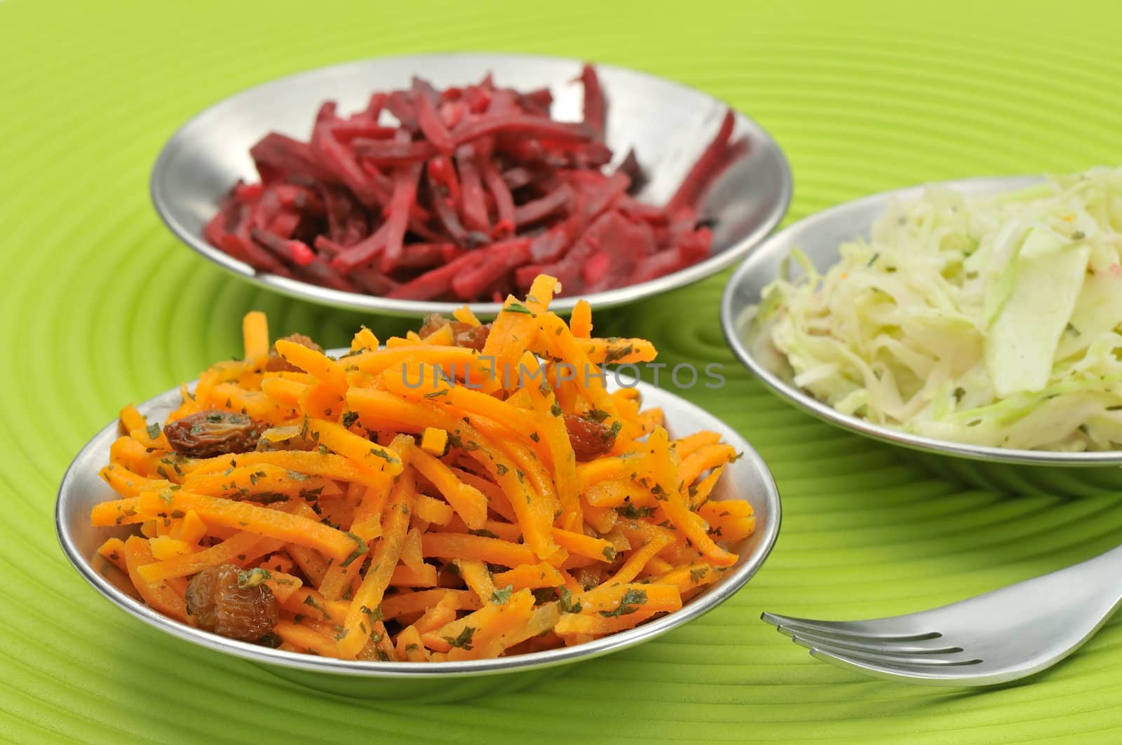 Grated carrots beetroot and white cabbage salad - focus on carrots