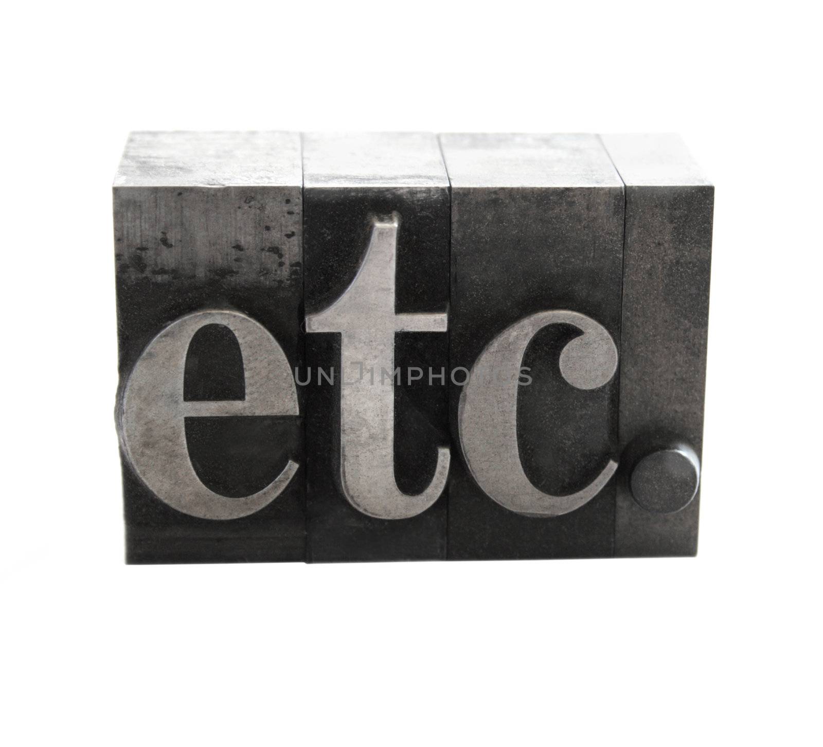 old metal letterpress letters form the word 'etc.' isolated on white