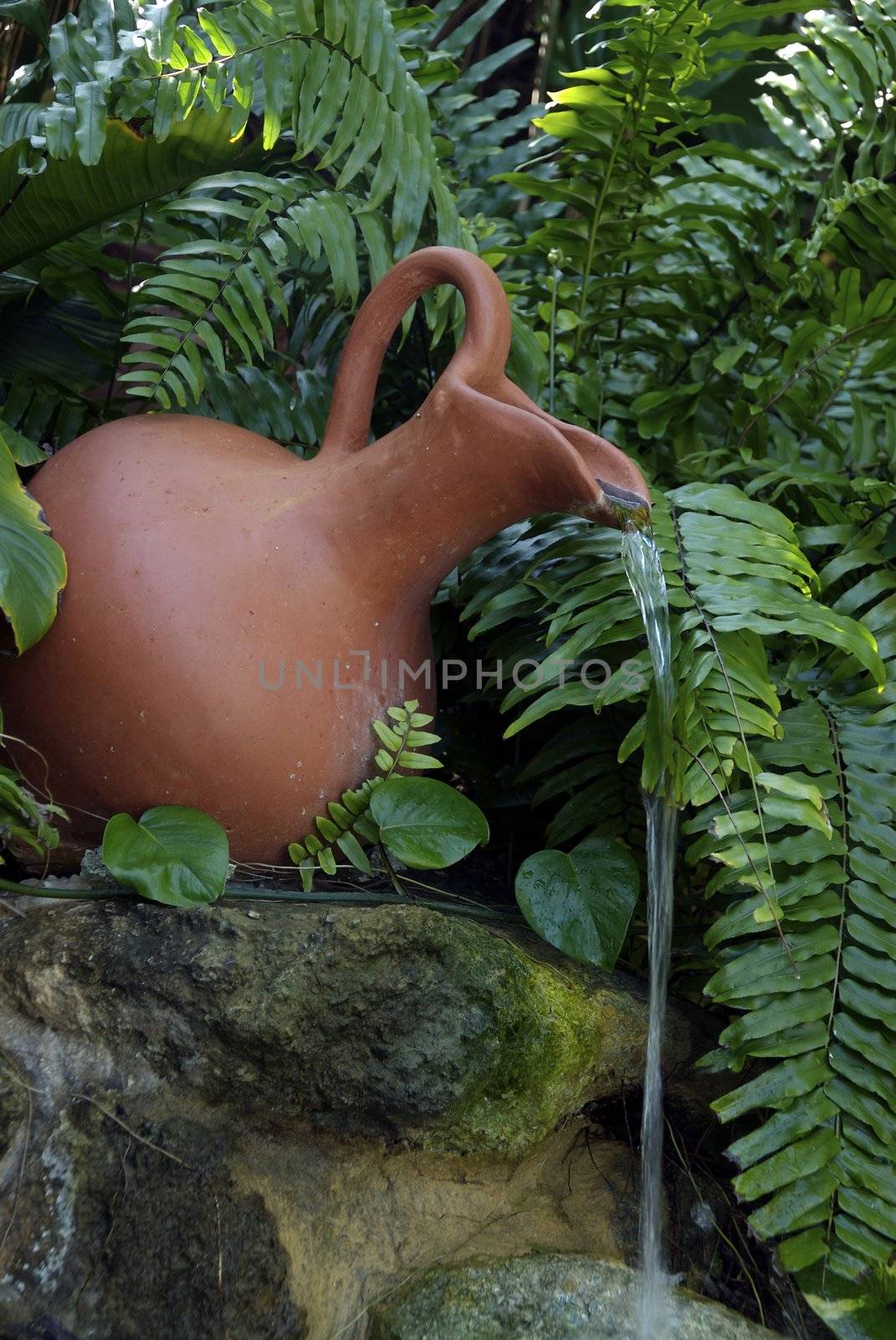 A clay water jug makes a decorative fountain