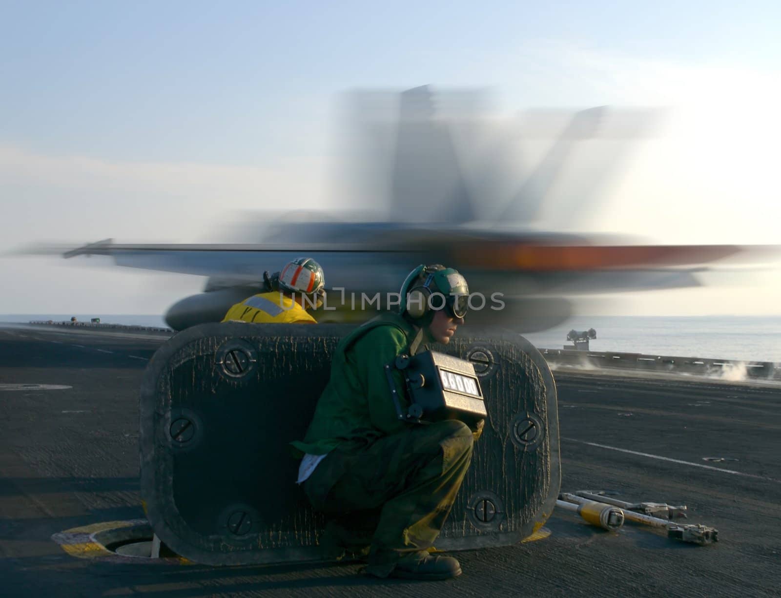 An F-18 Super Hornet rockets down the catapult track of a nuclear powered aircraft carrier