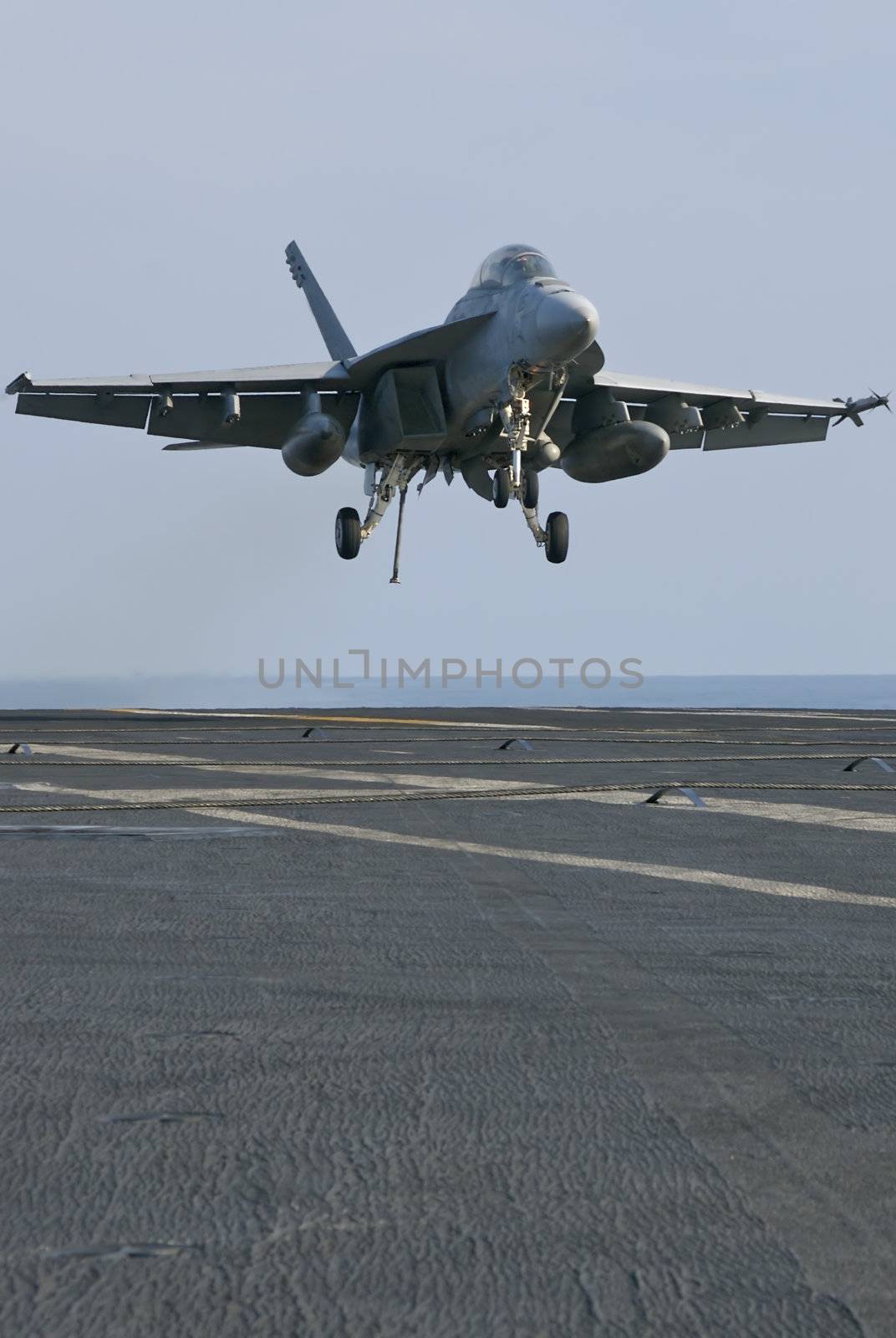 An F-18 Super Hornet moments away from trapping onboard a nuclear aircraft carrier