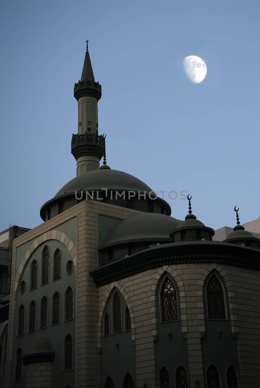 A Middle Eastern Mosque stands silently in the moonlight