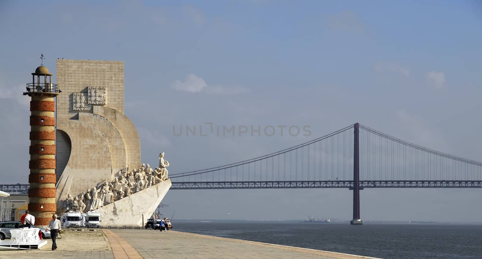 The Discoveries Monument and 25th of April Bridge in Lisbon, Portugal