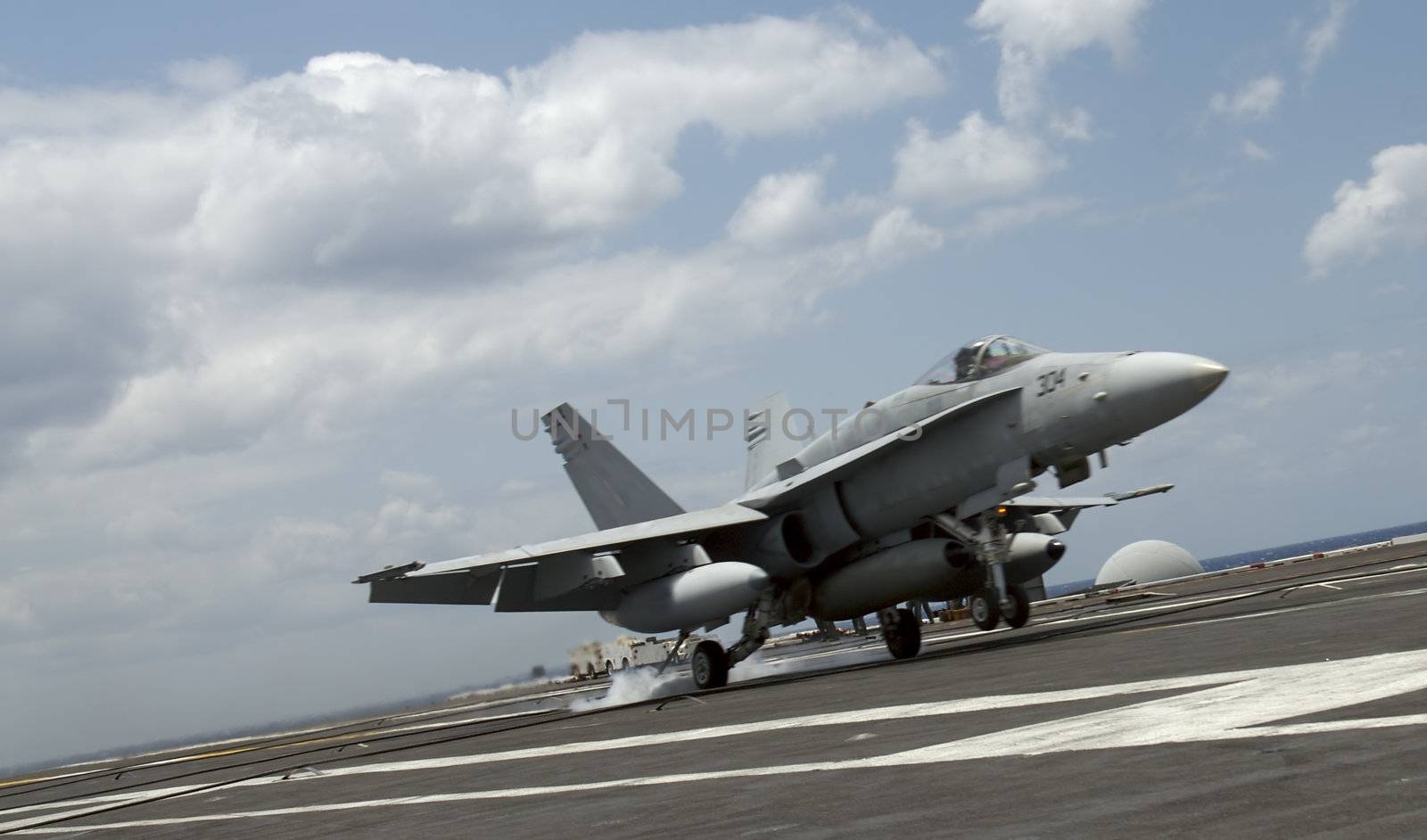 An F-18 Hornet lands aboard an aircraft carrier