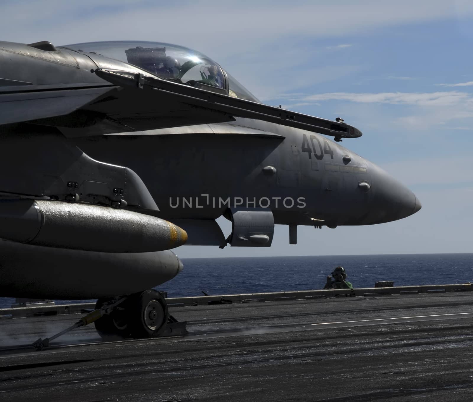An F-18 Hornet sits moment before being catapulted off the deck of an aircraft carrier