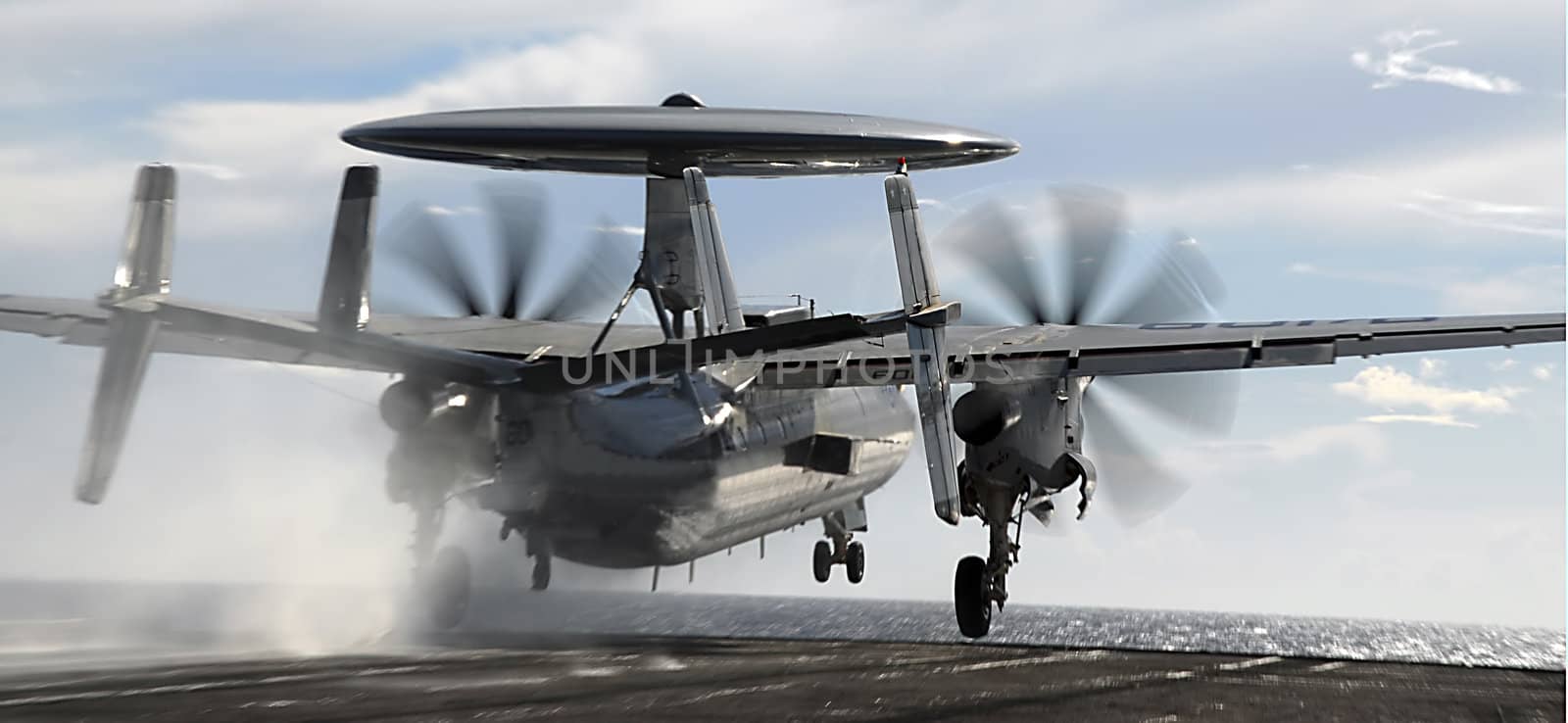 An E-2 Hawkeye is launched from the deck of an aircraft carrier 