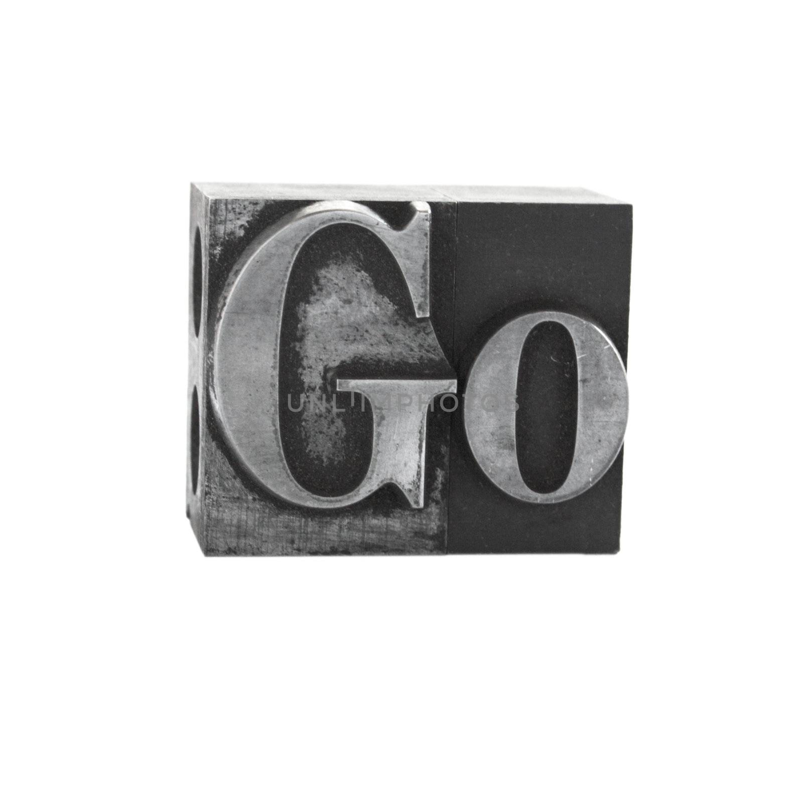 old metal letterpress letters form the word 'go' isolated on white