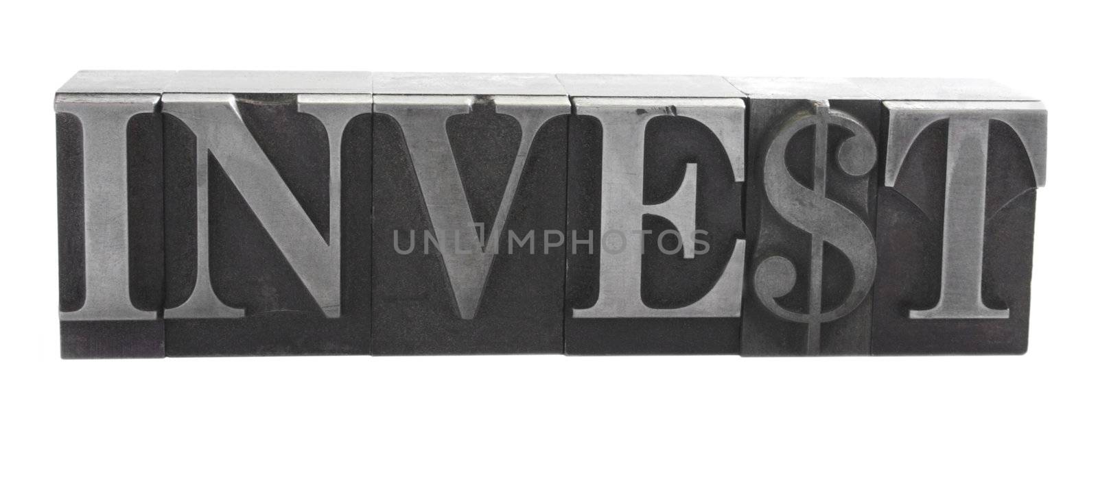 old metal letterpress letters form the word 'invest' isolated on white