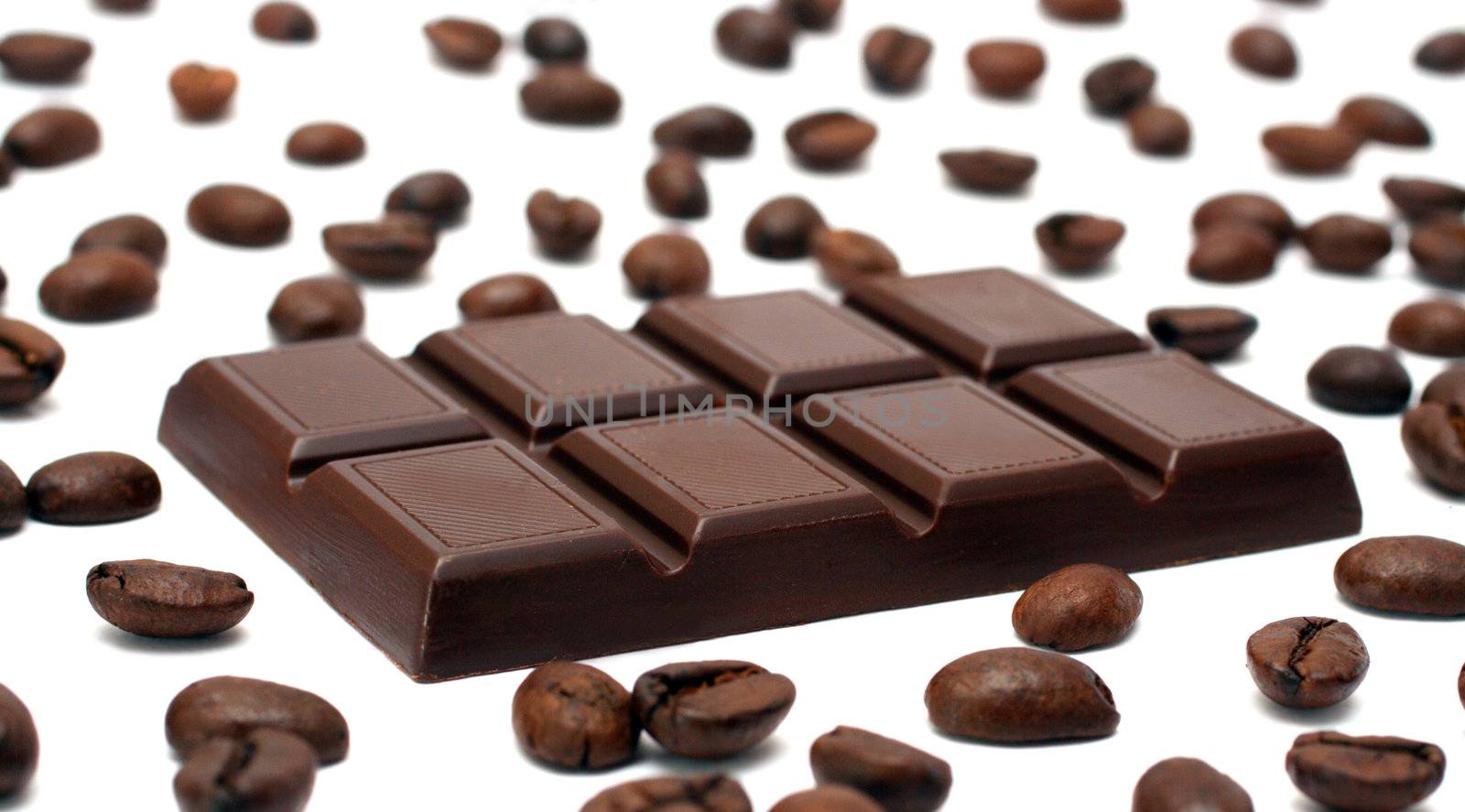 chocolate bar and coffee beans on white