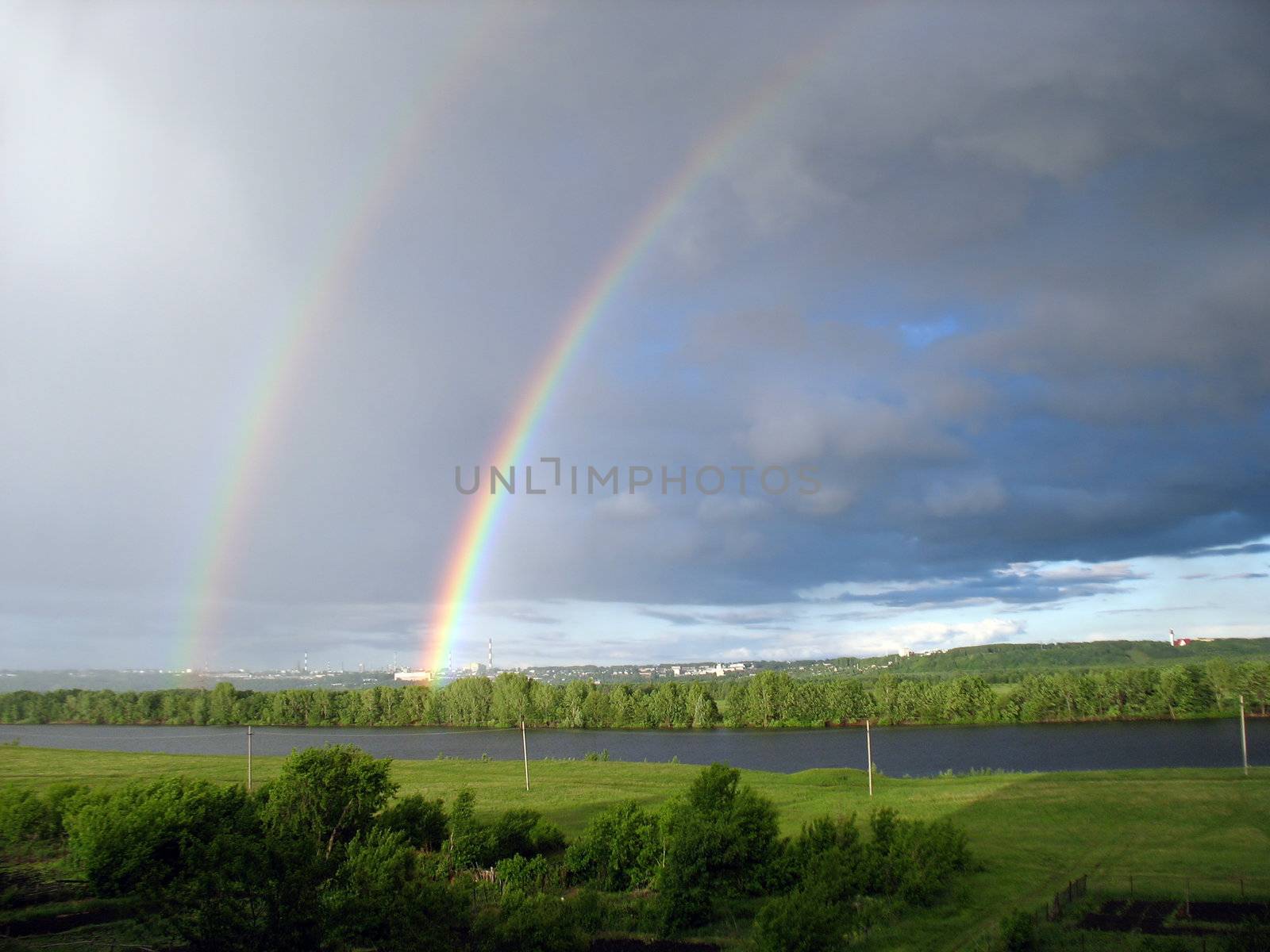 landscape with rainbow over lake by Mikko
