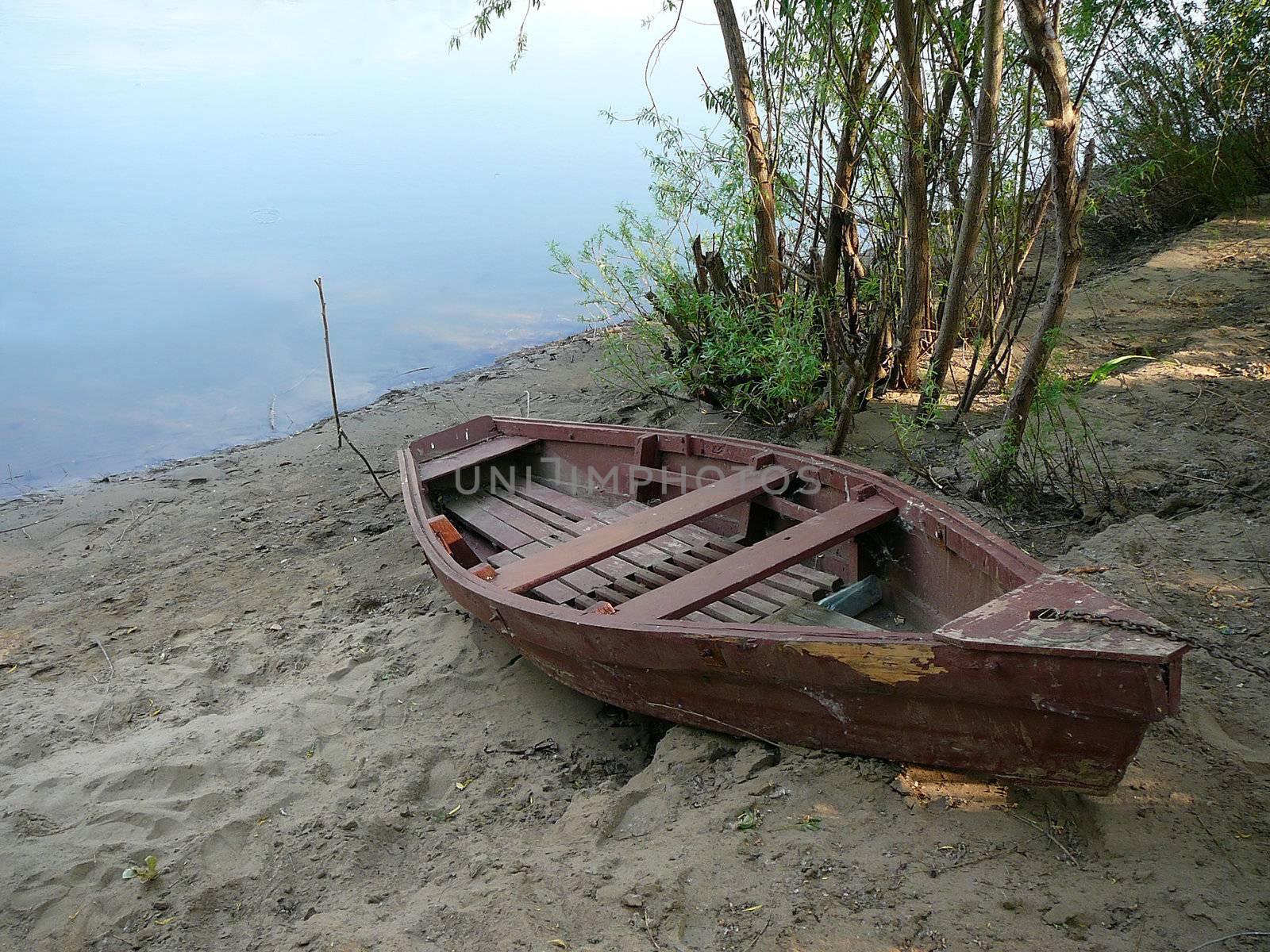 old obsolete wooden boat on river coast