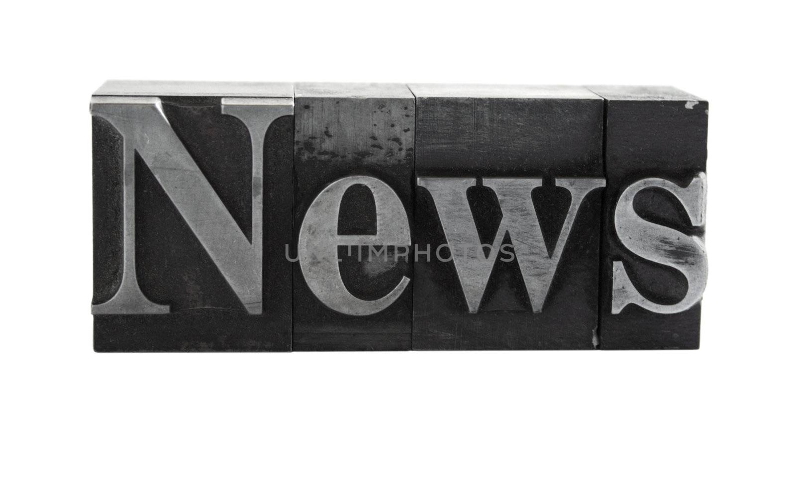 old metal letterpress letters form the word 'news' isolated on white