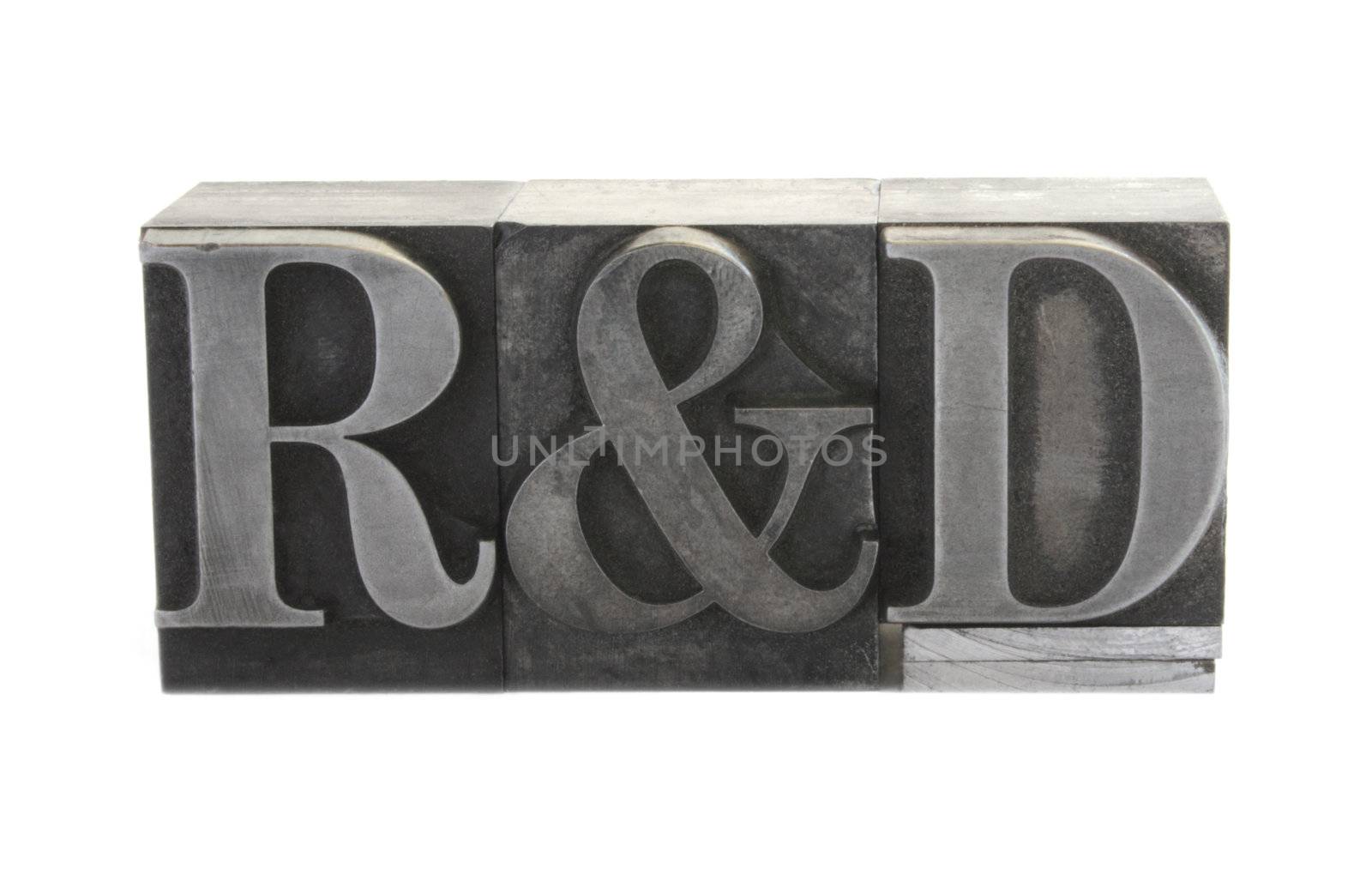 old, inkstained metal type letters form the term 'R&D'