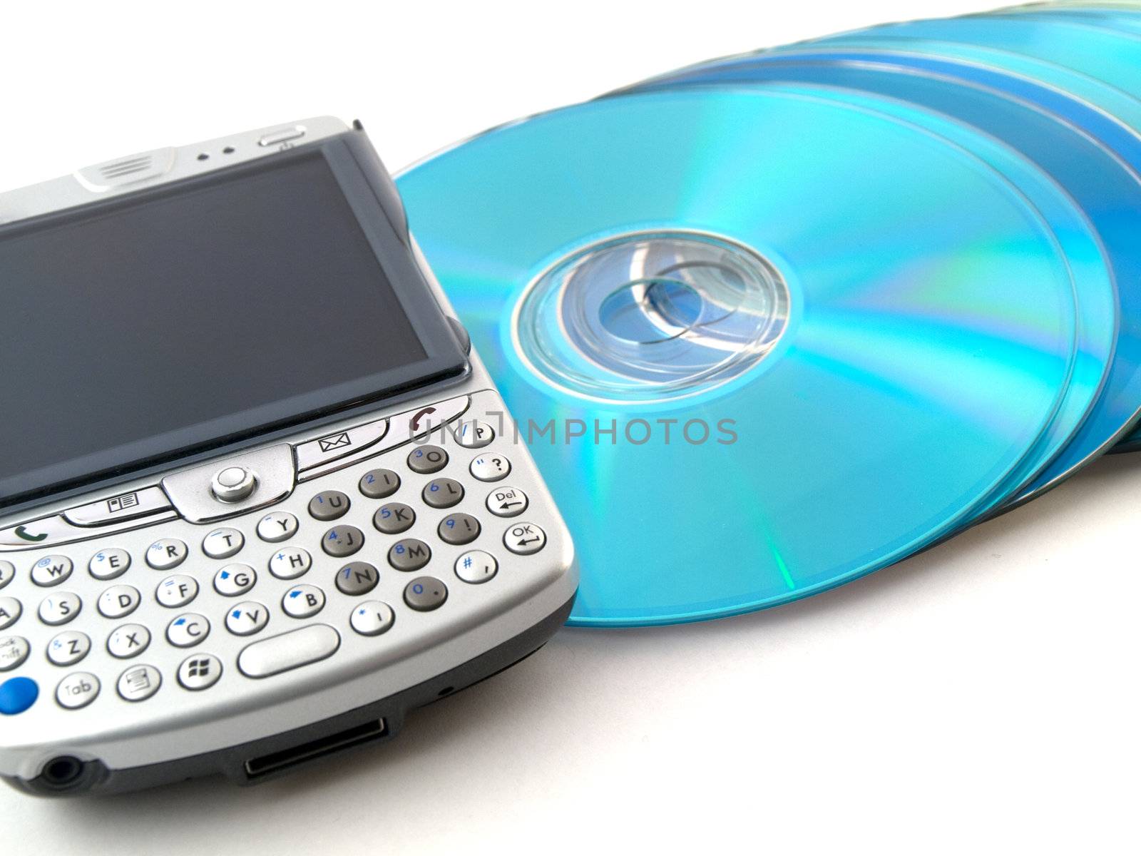 CDs DVDs and Mobile Phone PDA on White Background