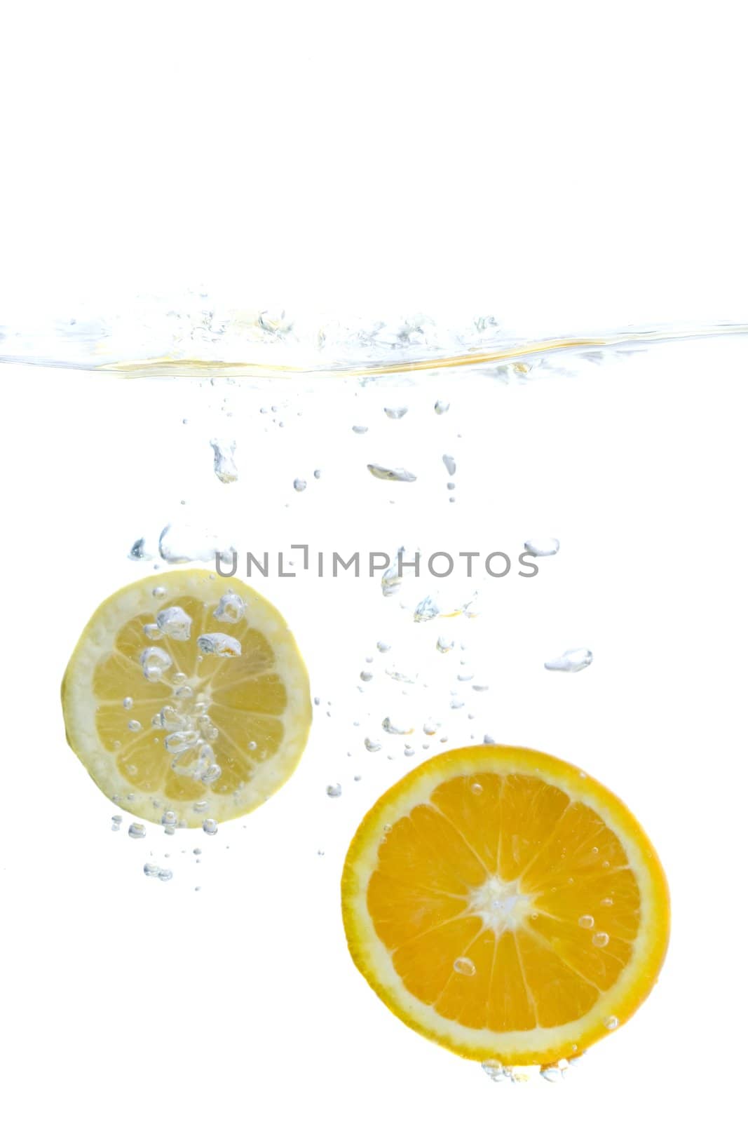 Big yellow lemon splashing in water