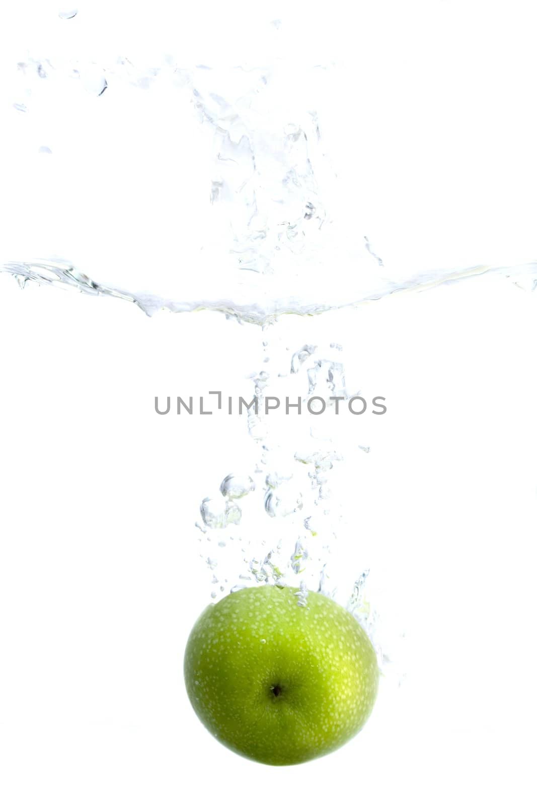 Big green apple splashing in water