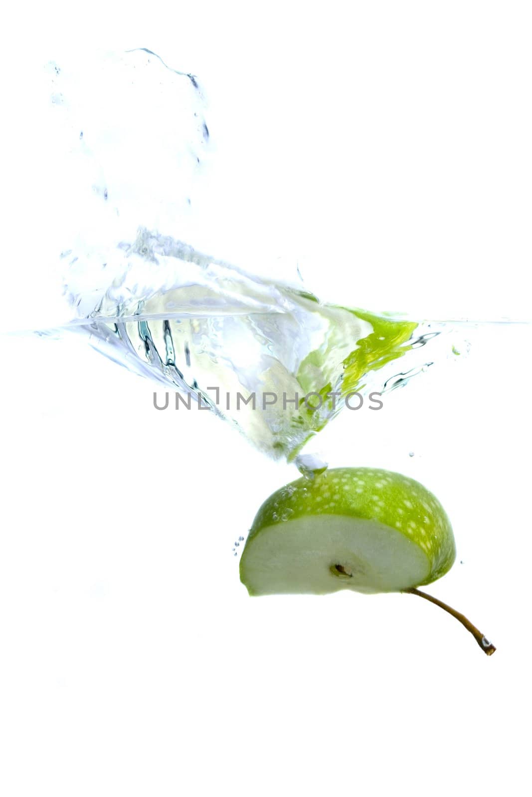 Big green apple splashing in water