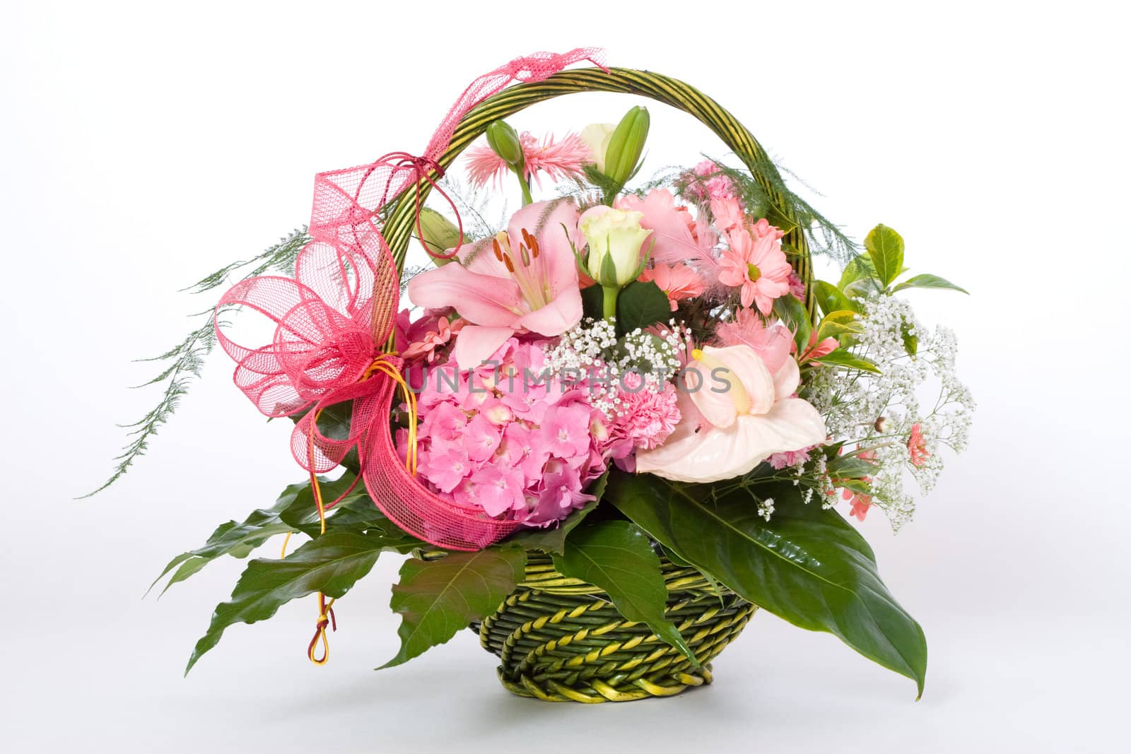 Various colorful flowers in green basket