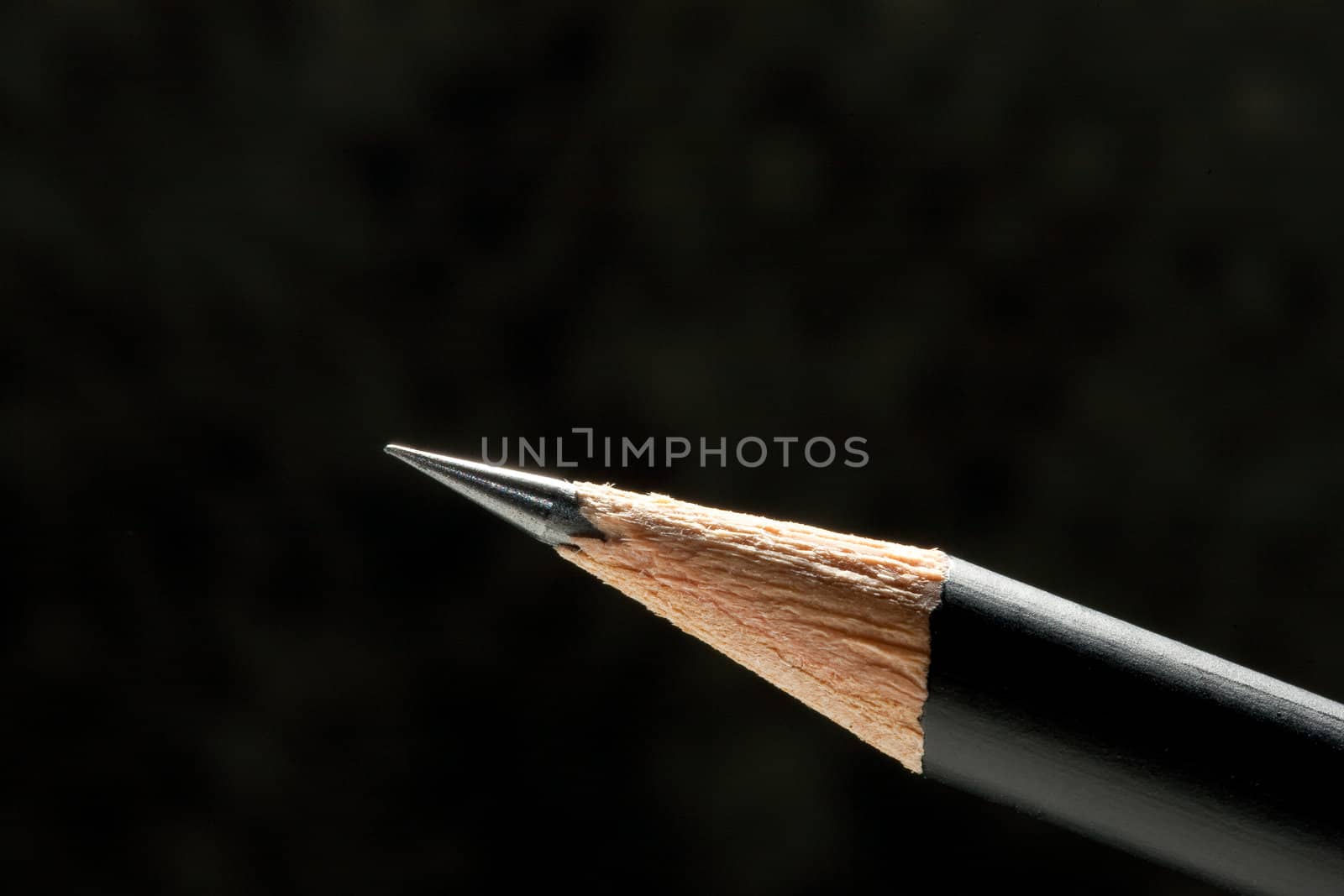 Close-up, studio, black pencil sharpened edge, is well defined on a black background
