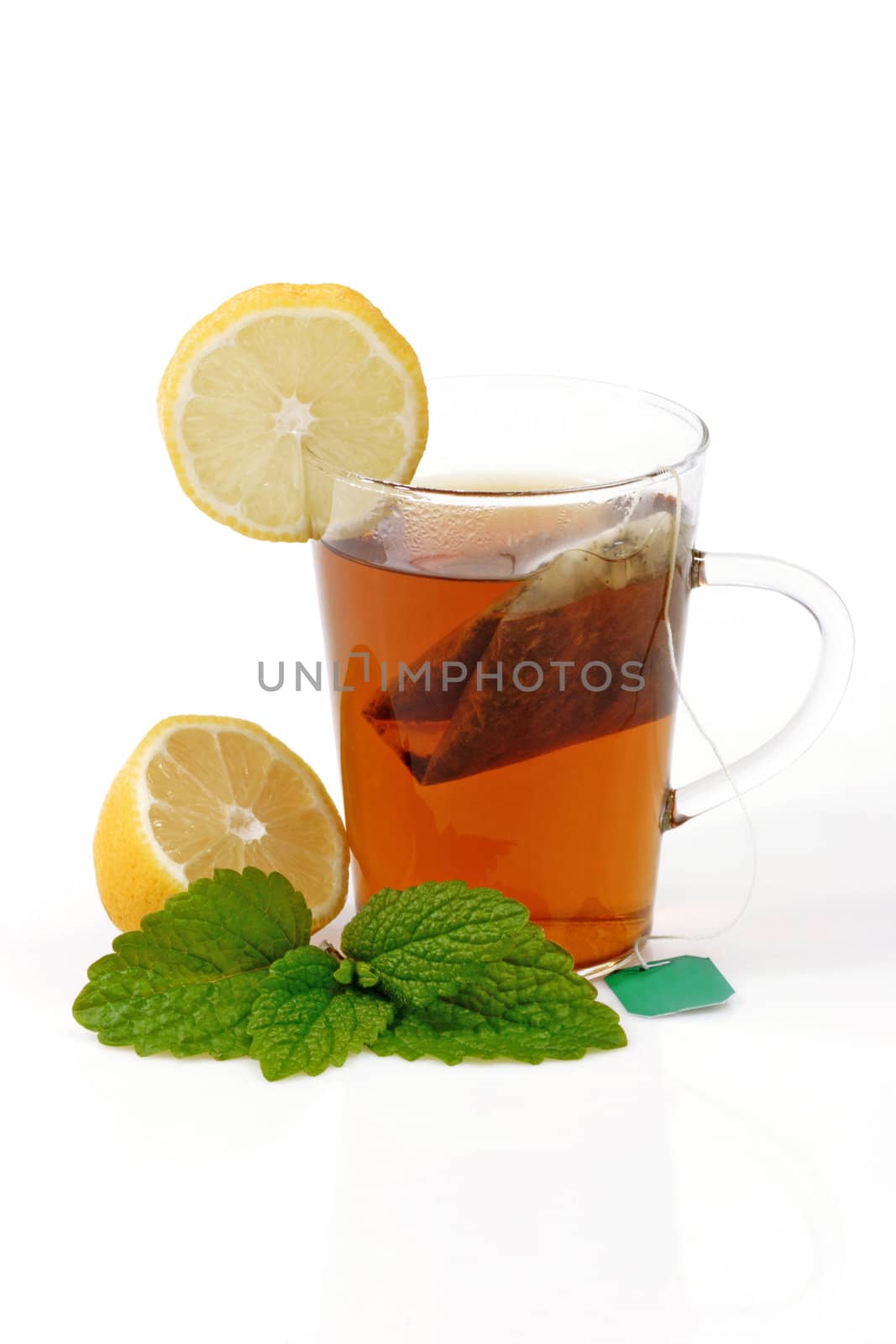 Peppermint tea in a glass on bright background