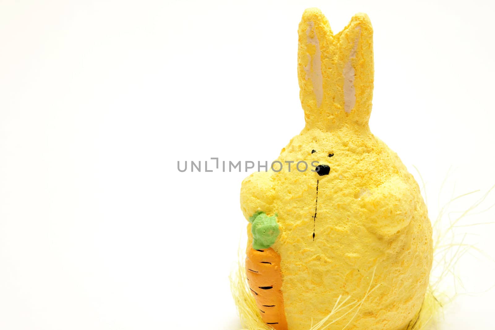 Stuffed bunny with carrot over white background