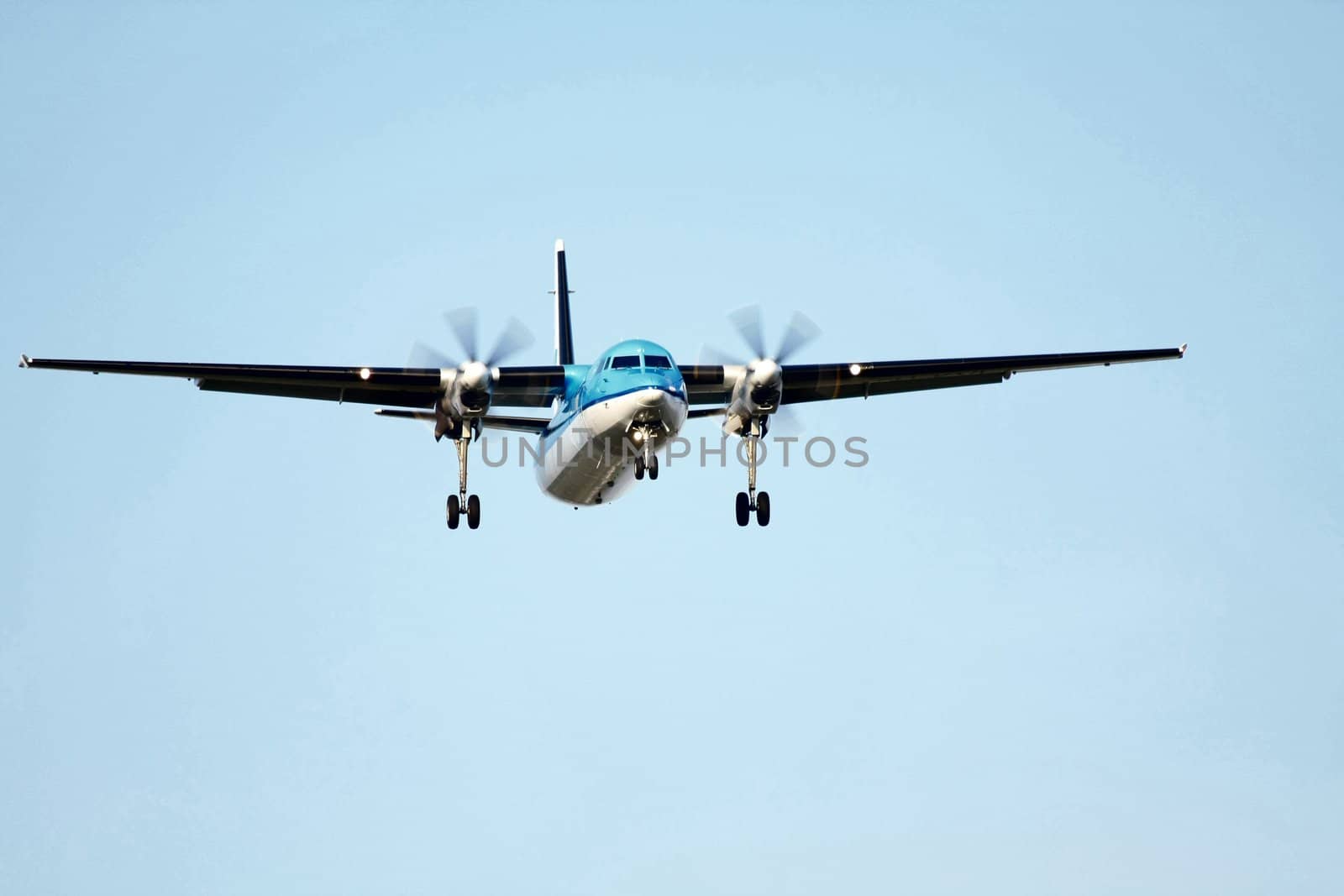 proppelor plane approaching runway by studioportosabbia