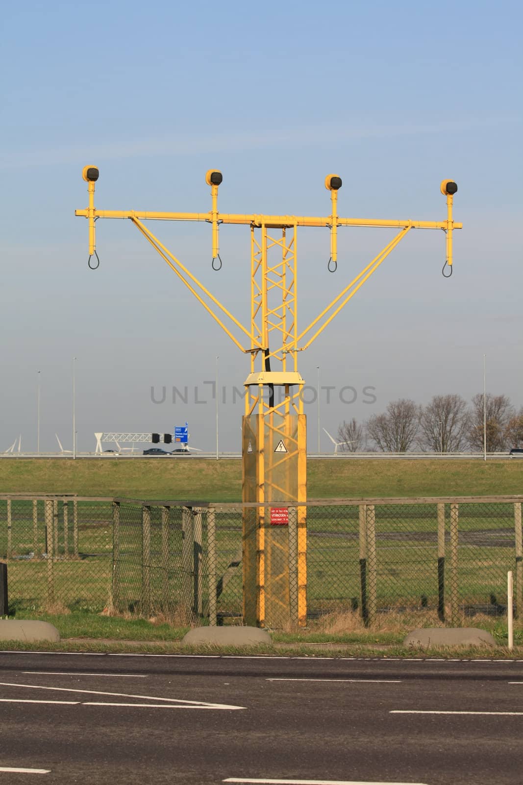 Traffic lights near an airport runway by studioportosabbia