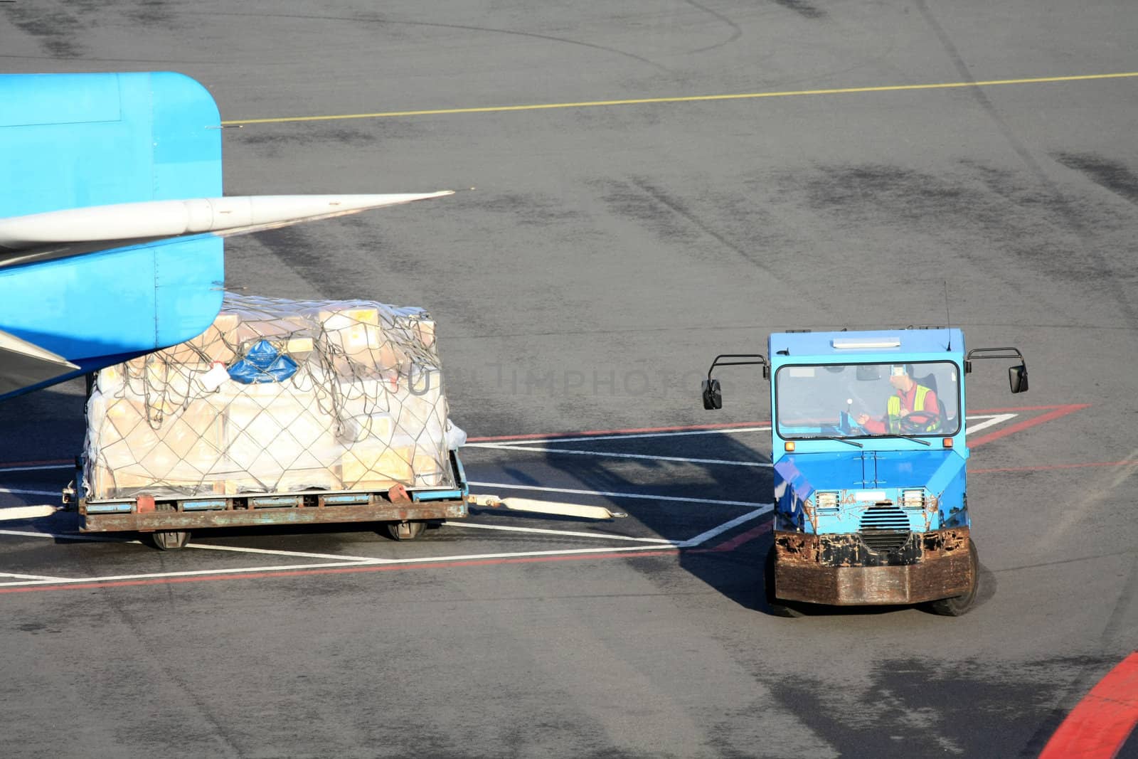 Cargo trailer near a plane at the airport