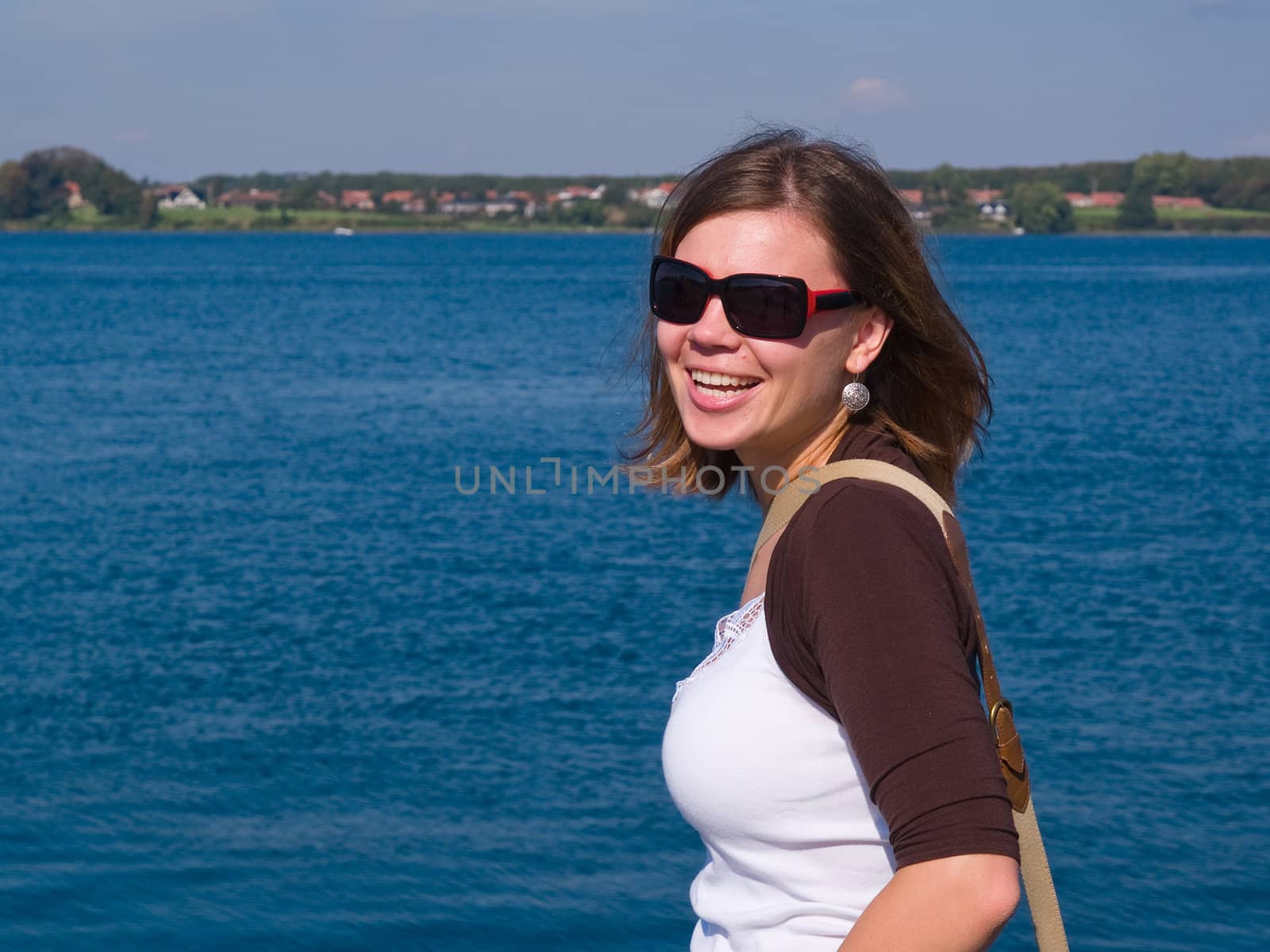 Beautiful attractive smiling young woman in a sunny beach