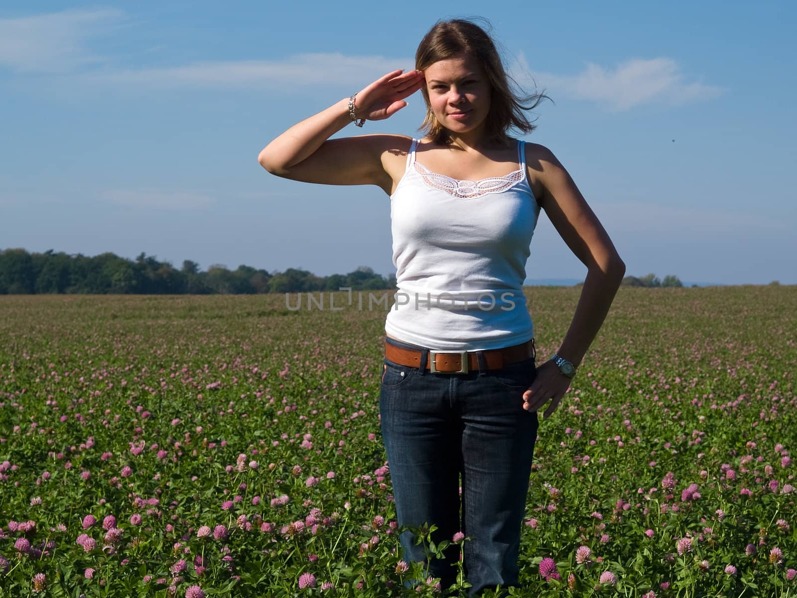 Young attractive sexy woman saluting and smiling Yes Sir!