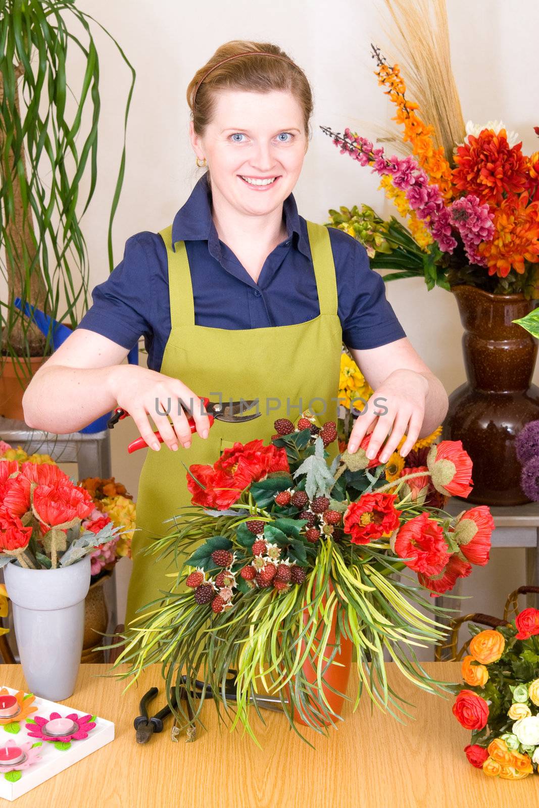 Young Florist in shop preparing flower decoration