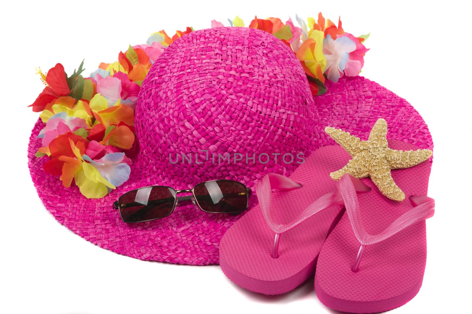 Colorful summer beachwear, flipflops, hat, orchids, sunglasses, and starfish