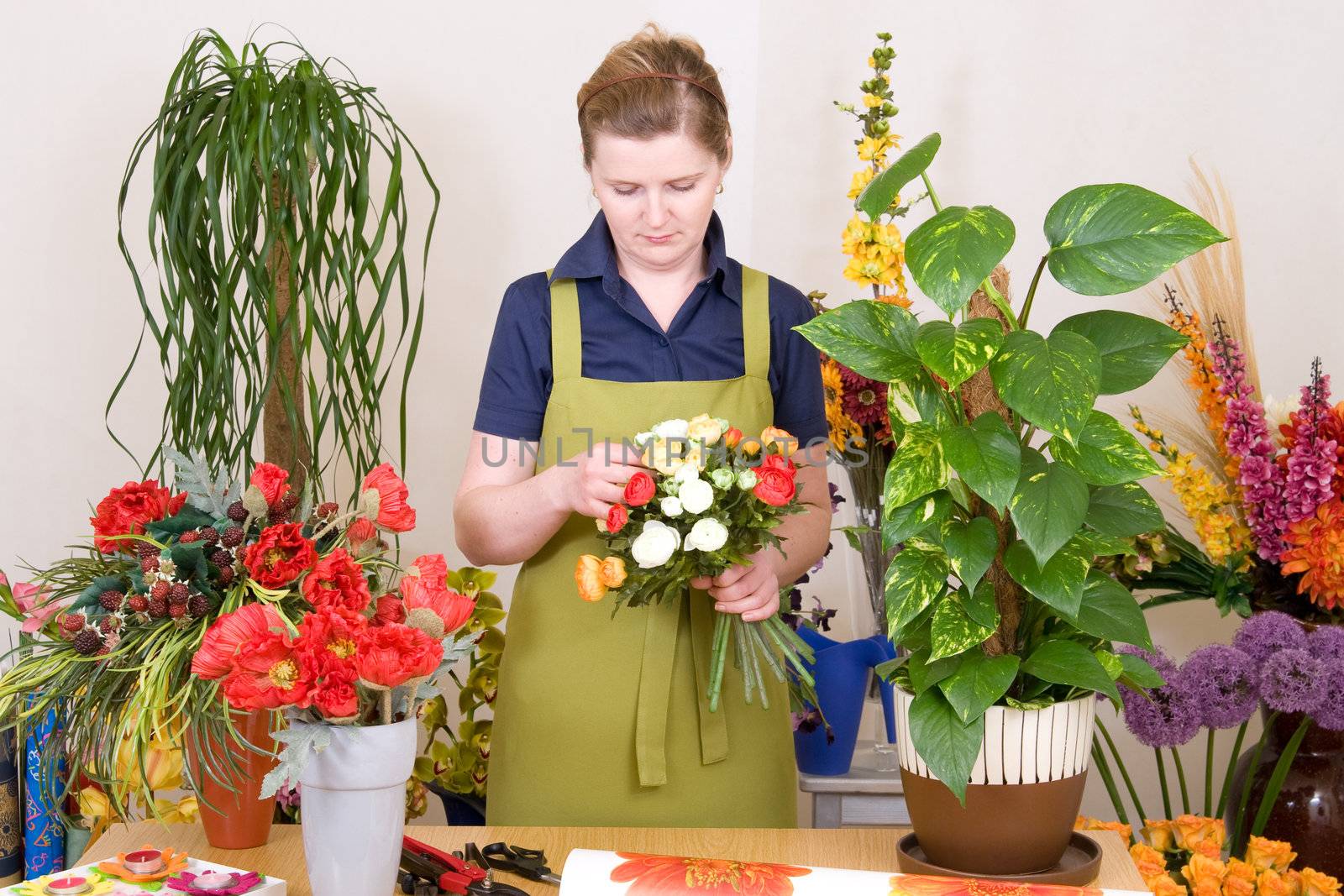 Young florist working on flower bouquet