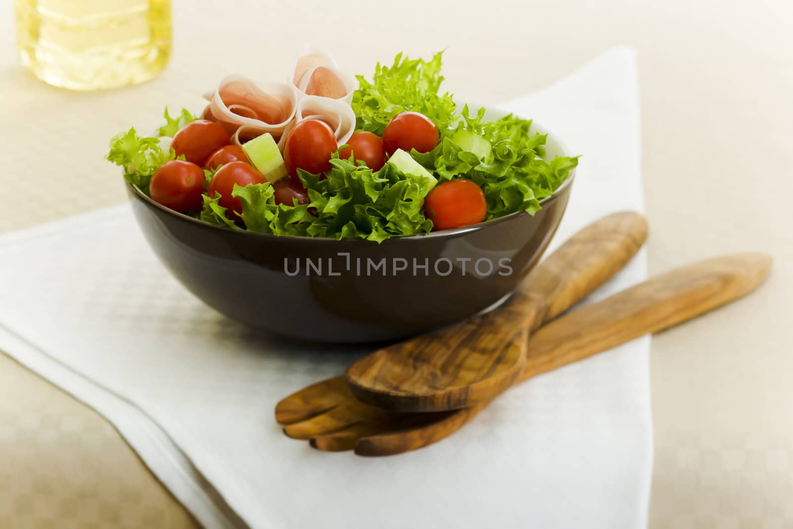 Prosciutto salad with wooden spoon on the table