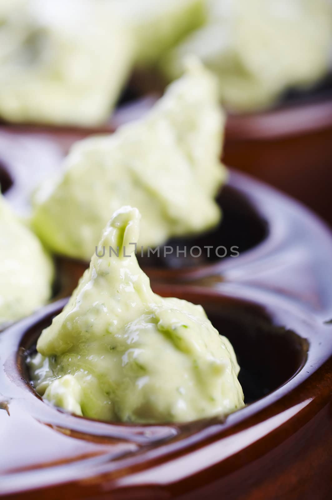 Uncooked snails with garlic and butter on the table