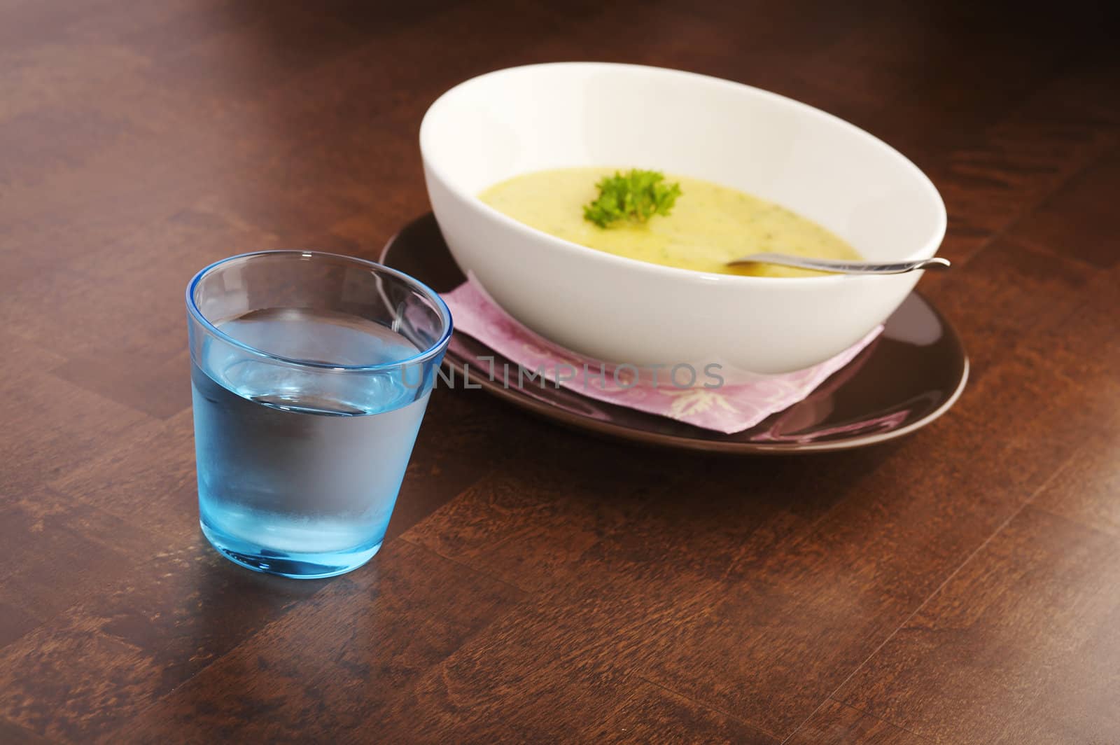 Yellow vegetable soup on a dark wooden table