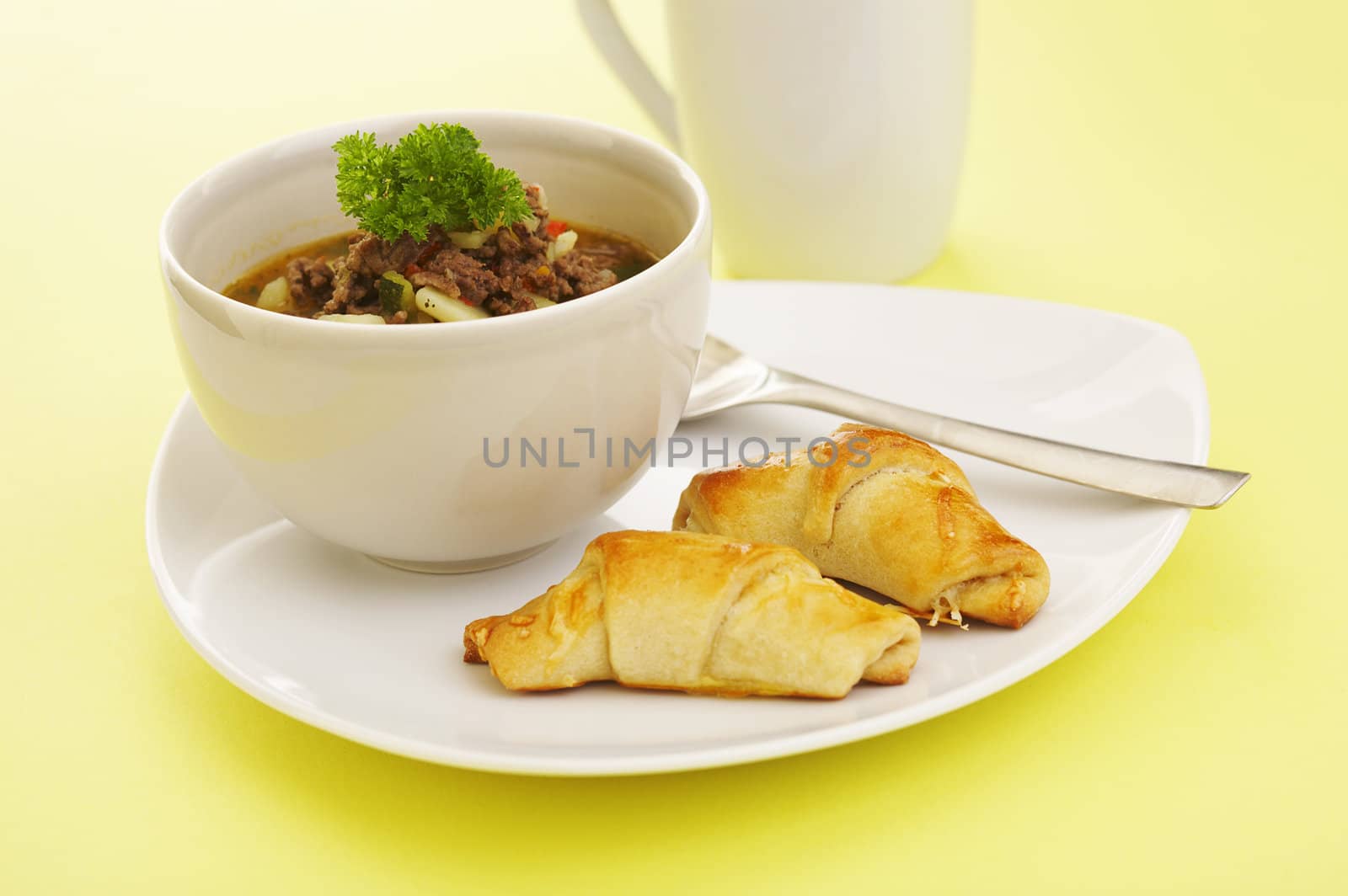 Lunch soup (vegetables, grounded meat) and baked cheese rolls