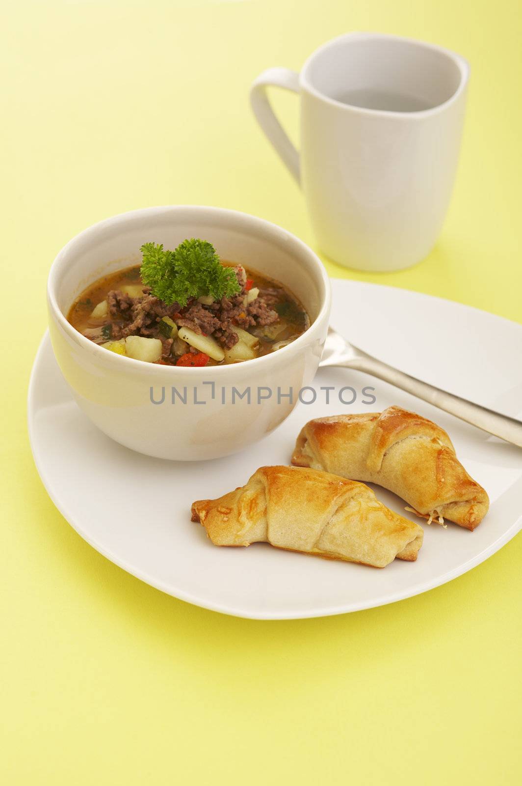 Lunch soup (vegetables and grounded meat) and baked cheese rolls