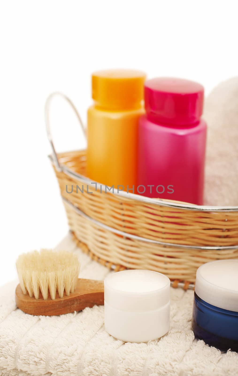 Spa settings with flower, shampoo, candle and towel