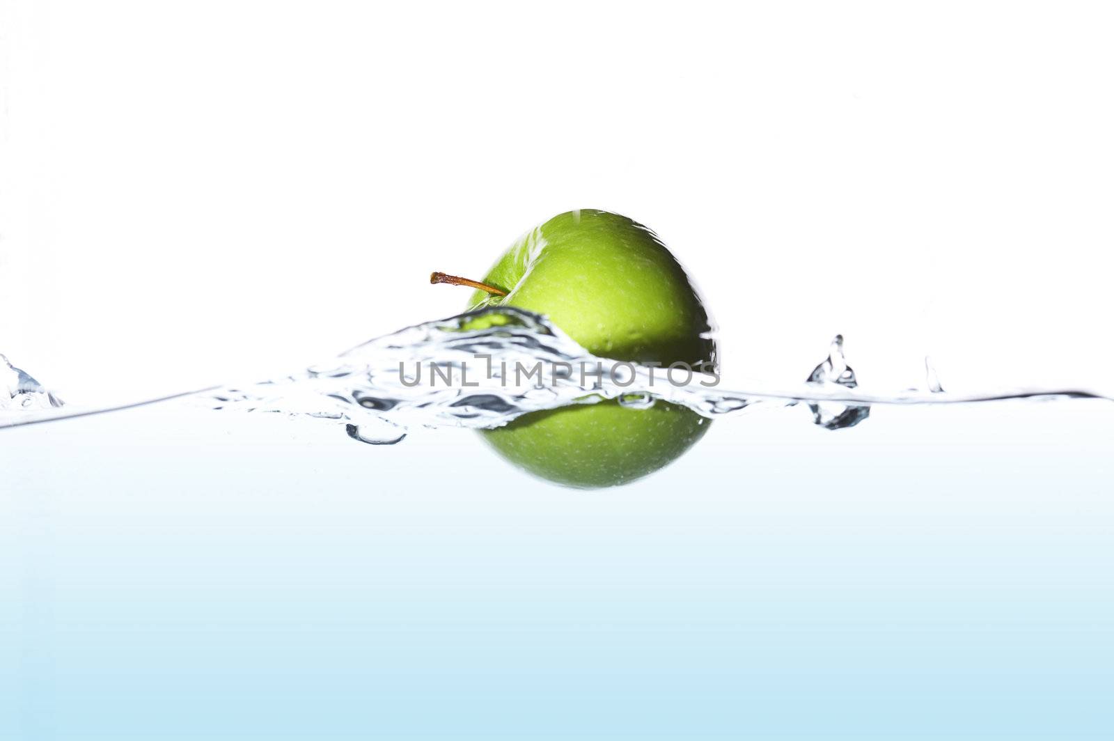 Isolated green apple surfing on the wave