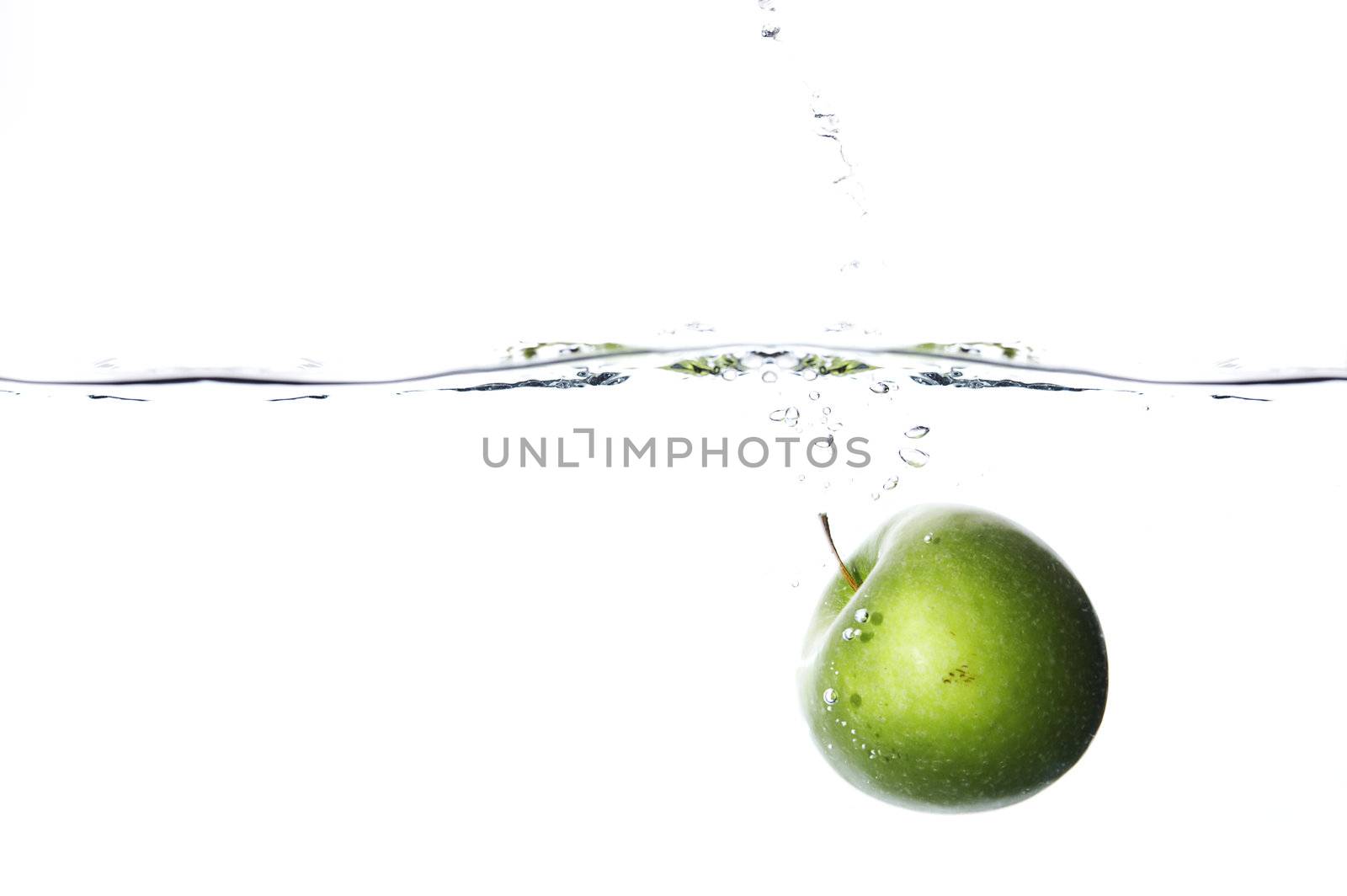 Apple dropped to water on white background