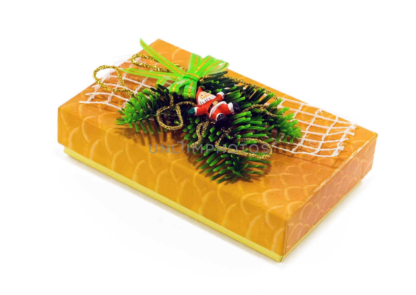 A yellow box decorated with pine, ribbons and Santa 