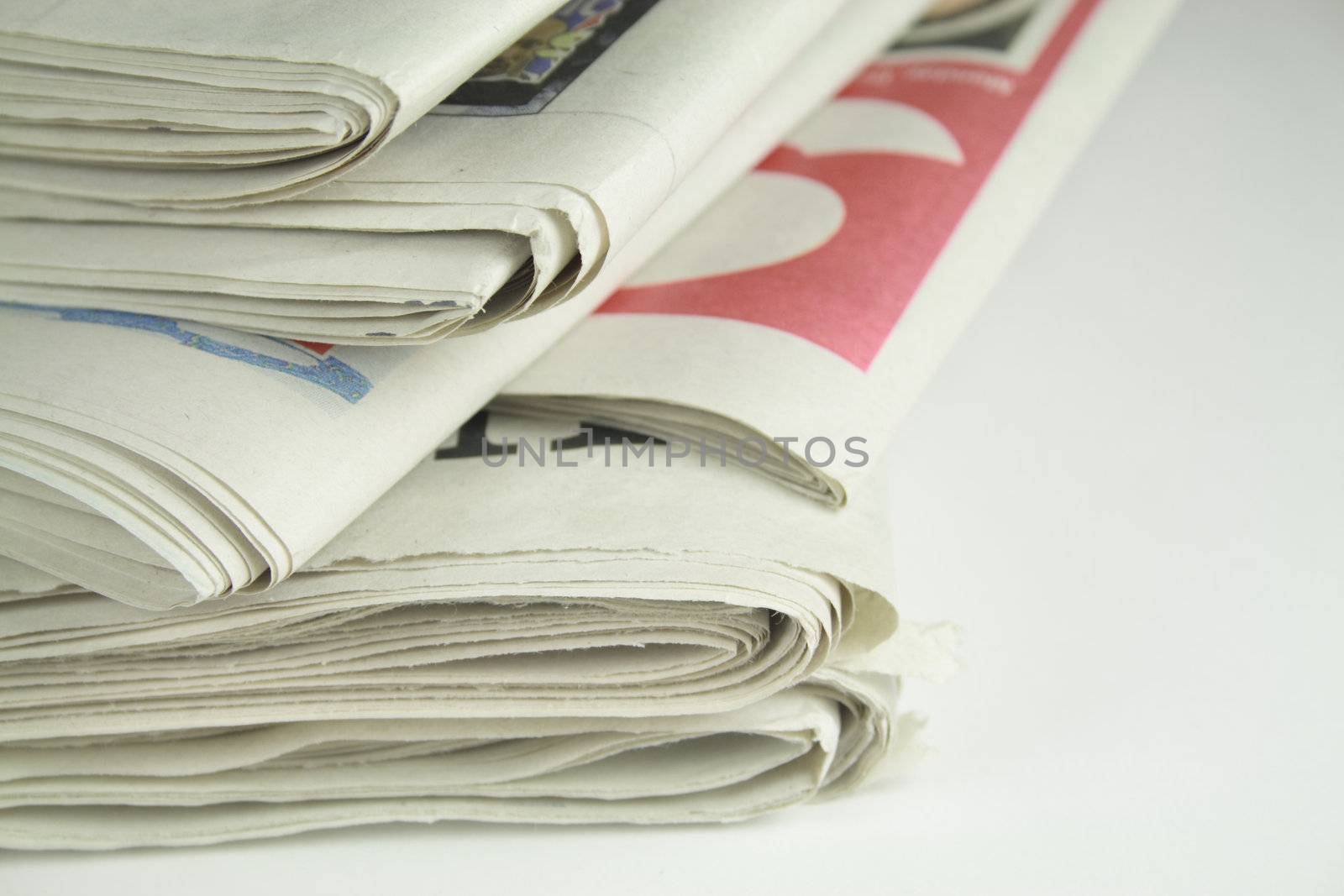 pile of daily newspapers isolated over a white background