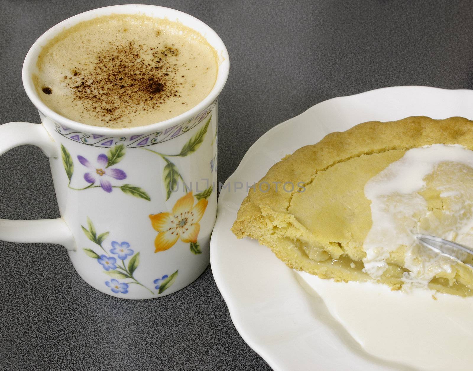 mug of cappucino and apple-pie and cream a tea time snack